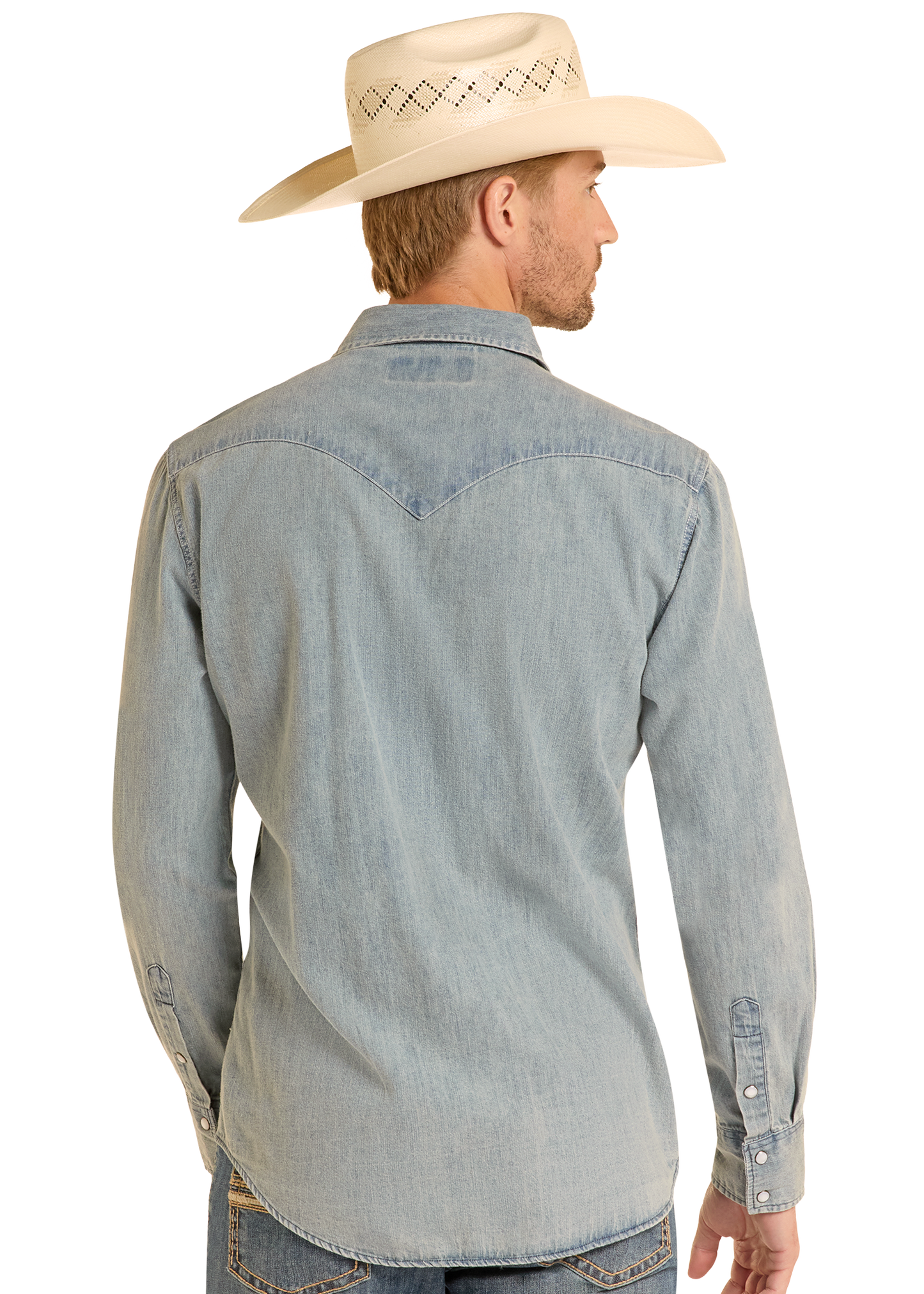 A man stands with his back to the camera against a plain light background, wearing a Rock & Roll Denim Slim Fit Medium Wash Denim Snap Shirt, blue jeans, and a cream cowboy hat.