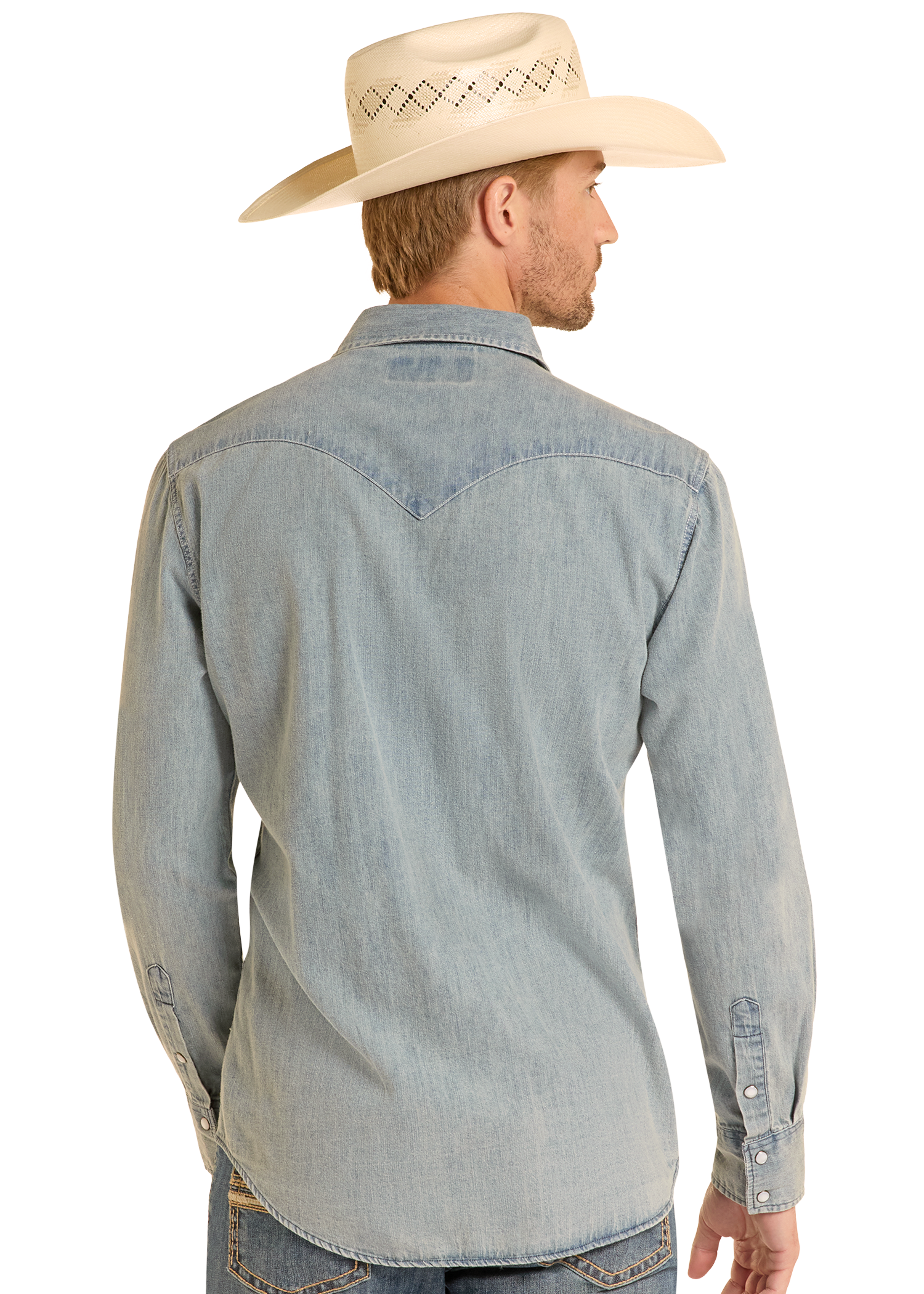 A man stands with his back to the camera against a plain light background, wearing a Rock & Roll Denim Slim Fit Medium Wash Denim Snap Shirt, blue jeans, and a cream cowboy hat.