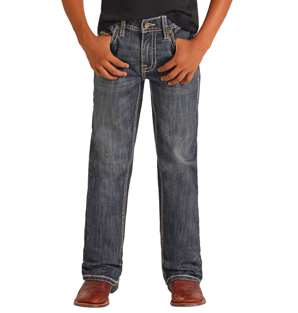 A person wearing Rock & Roll Denim Boys' Regular Fit Raised Embroidery Bootcut Jeans, a black shirt, and brown leather shoes stands with hands in pockets against a white background.