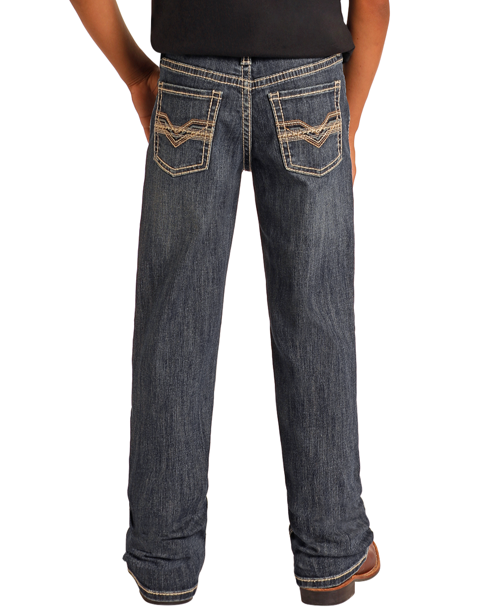 A person stands facing away with hands on hips, wearing Rock & Roll Denim Boys' Regular Fit Bootcut Jeans in dark blue featuring raised embroidery on the back pockets.