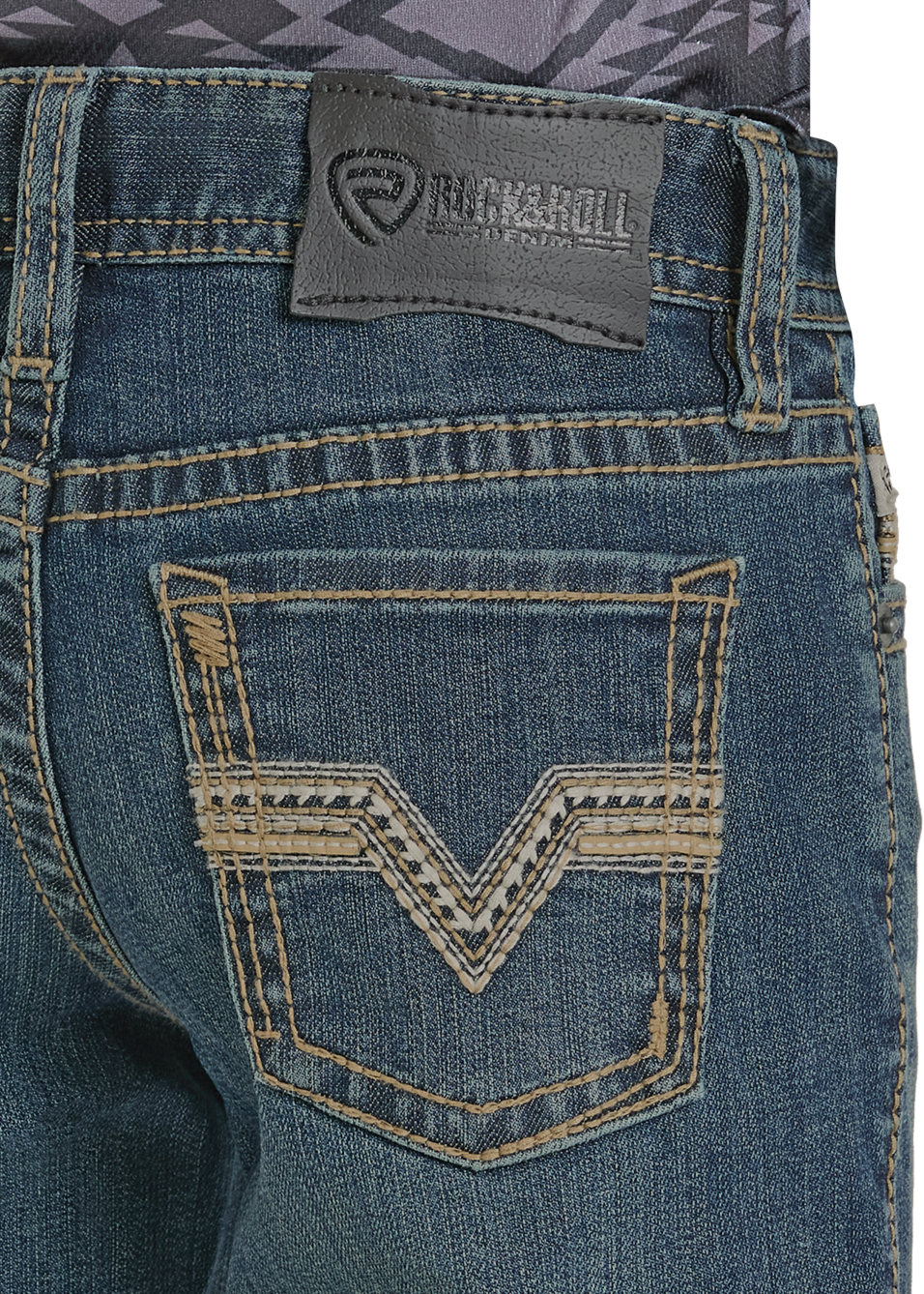 Close-up of the back pocket of Boys' Regular Fit Signature Medium Wash Bootcut Jeans by Rock & Roll Denim, with tan stitching, a V-shaped decorative pattern, and a rectangular leather brand patch above the pocket.