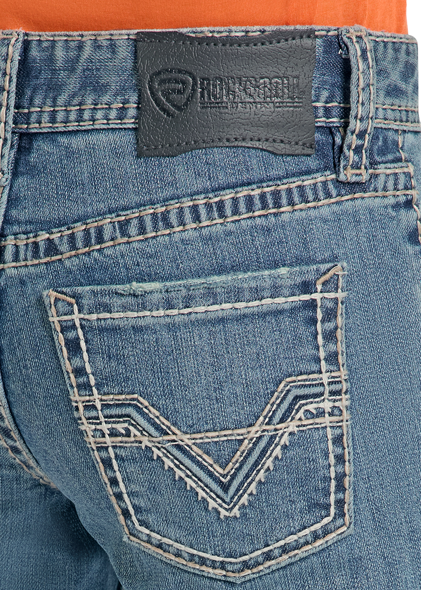 Close-up of the back waistband and pocket area of blue denim jeans, showing a dark gray leather patch with the Renegade logo and white contrast stitching.