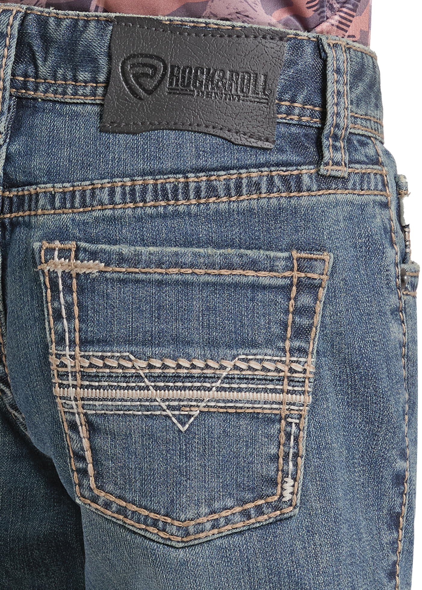 Close-up of the back waistband and back pocket of blue denim jeans with contrast stitching and a Rockroll brand patch.