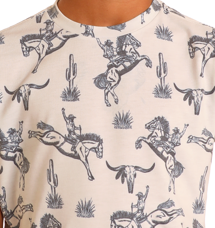 Close-up of the Rock & Roll Denim Boys' Bronco Graphic Tee, a cream-colored shirt featuring an adventurous sketch-like black pattern with cowboys on horses, cacti, steer skulls, and tufts of grass.