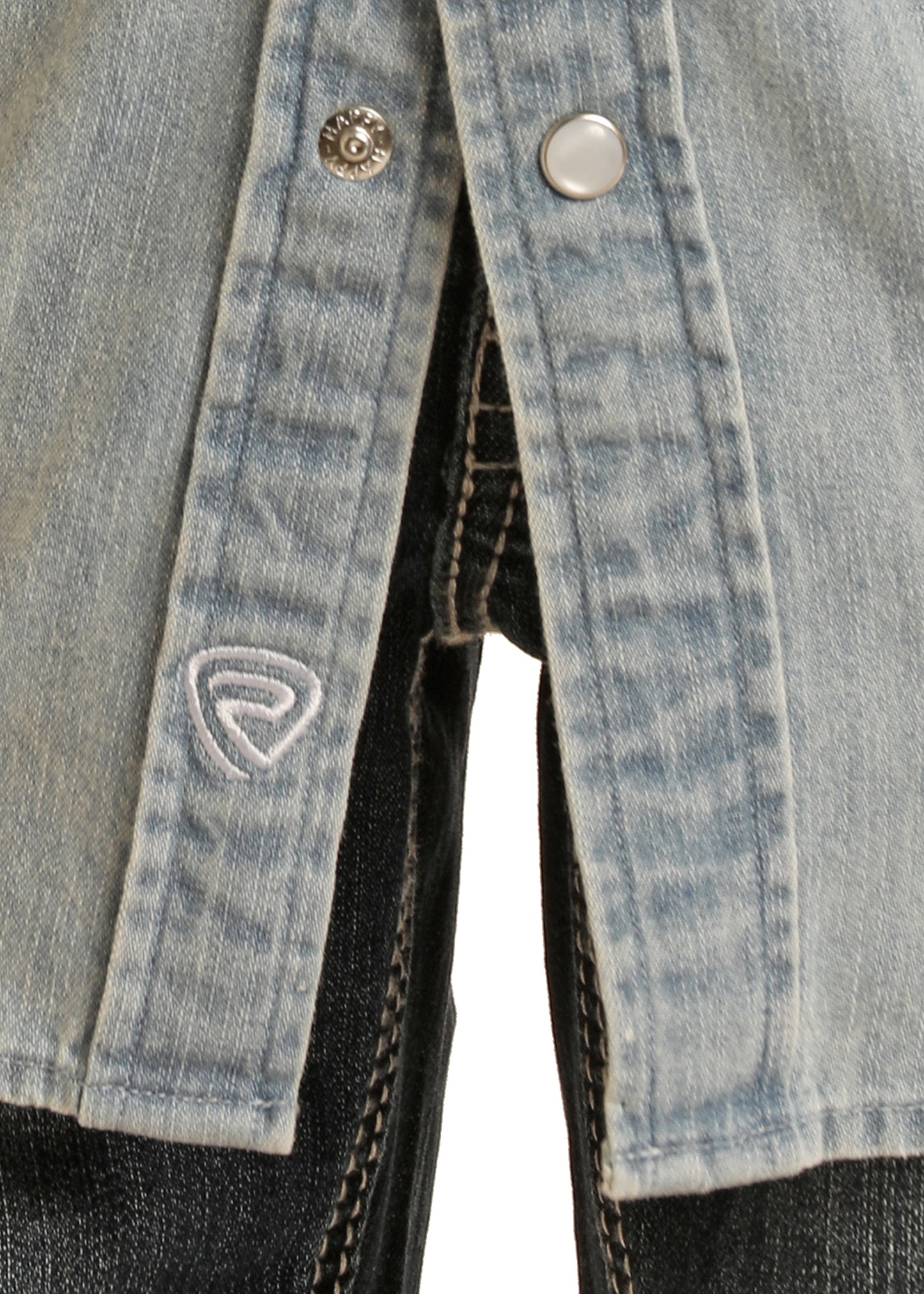 Close-up of a denim jacket with buttons and a brand logo on a white background