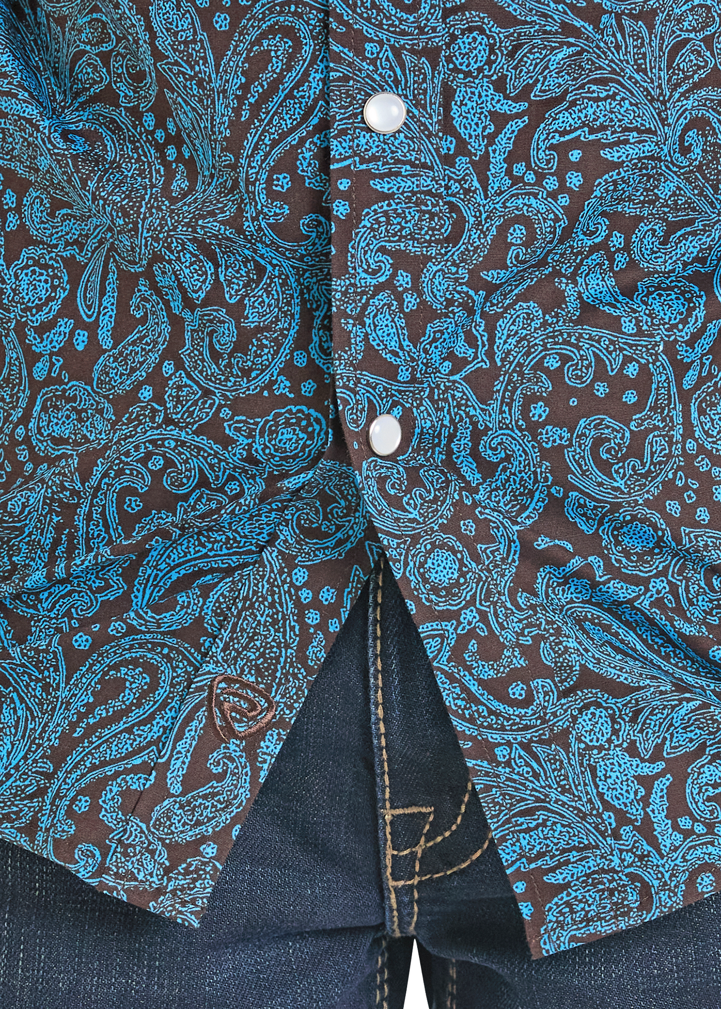 Close-up of a shirt with blue paisley pattern on a brown background