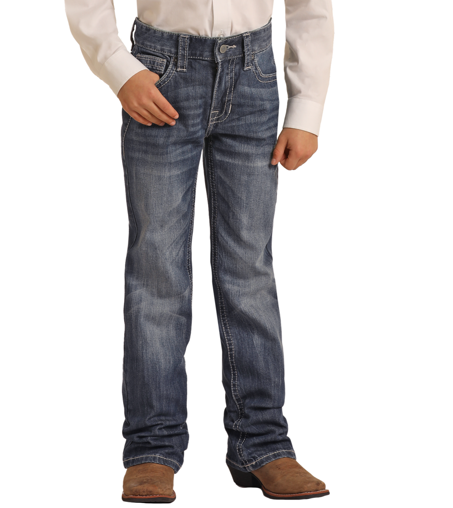 A person wearing a white long-sleeve shirt, brown cowboy boots, and Rock & Roll Denim Boys' Regular Fit Light Grey Top-Stitching Bootcut Jeans stands with one hand in a pocket against a plain background.