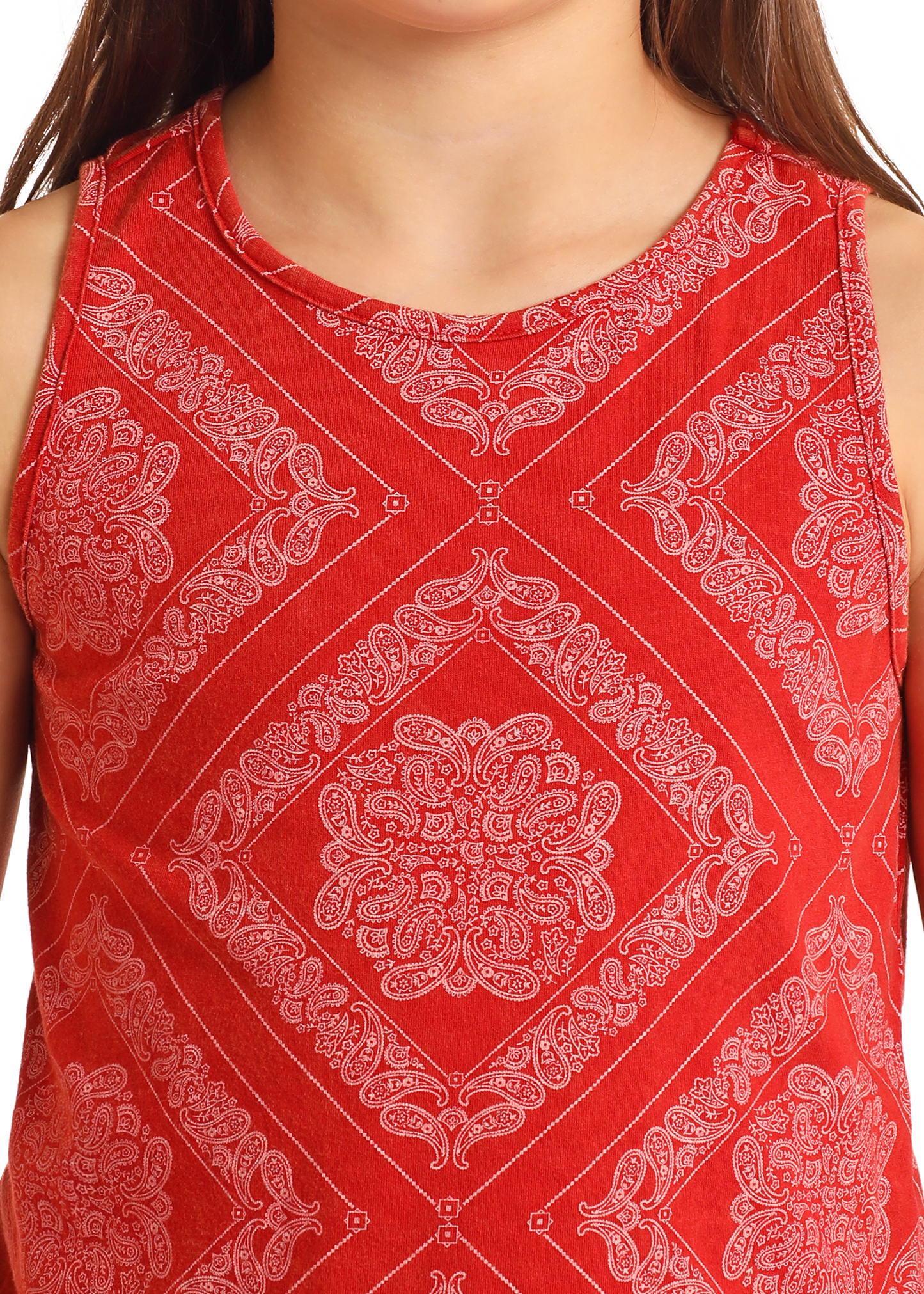 A girl wears the Rock & Roll Denim Girls' Bandana Fringe Tank, featuring a red bandana print with a white paisley design. The tank's neck, shoulders, and playful fringe hem are visible.