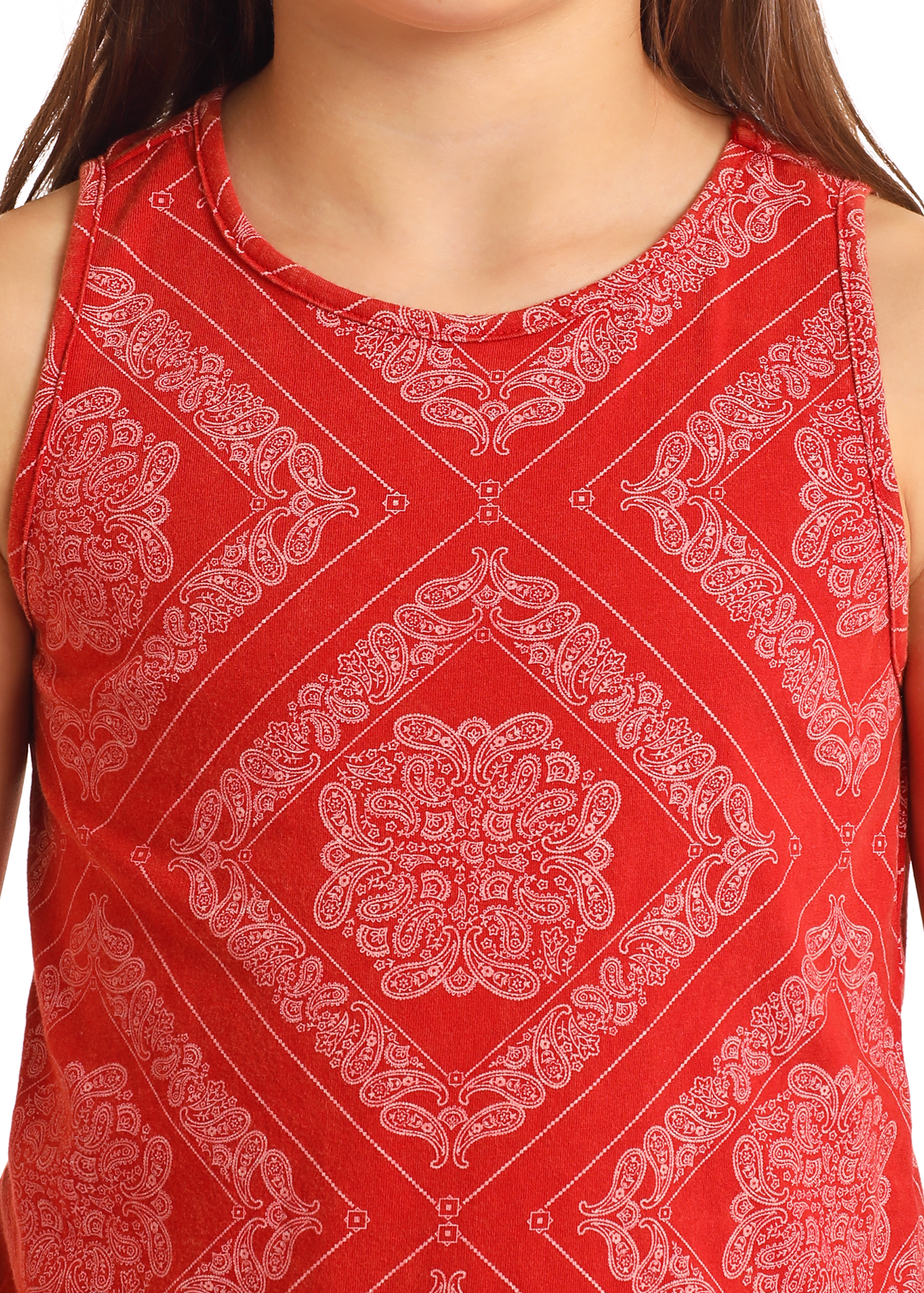 A girl wears the Rock & Roll Denim Girls' Bandana Fringe Tank, featuring a red bandana print with a white paisley design. The tank's neck, shoulders, and playful fringe hem are visible.