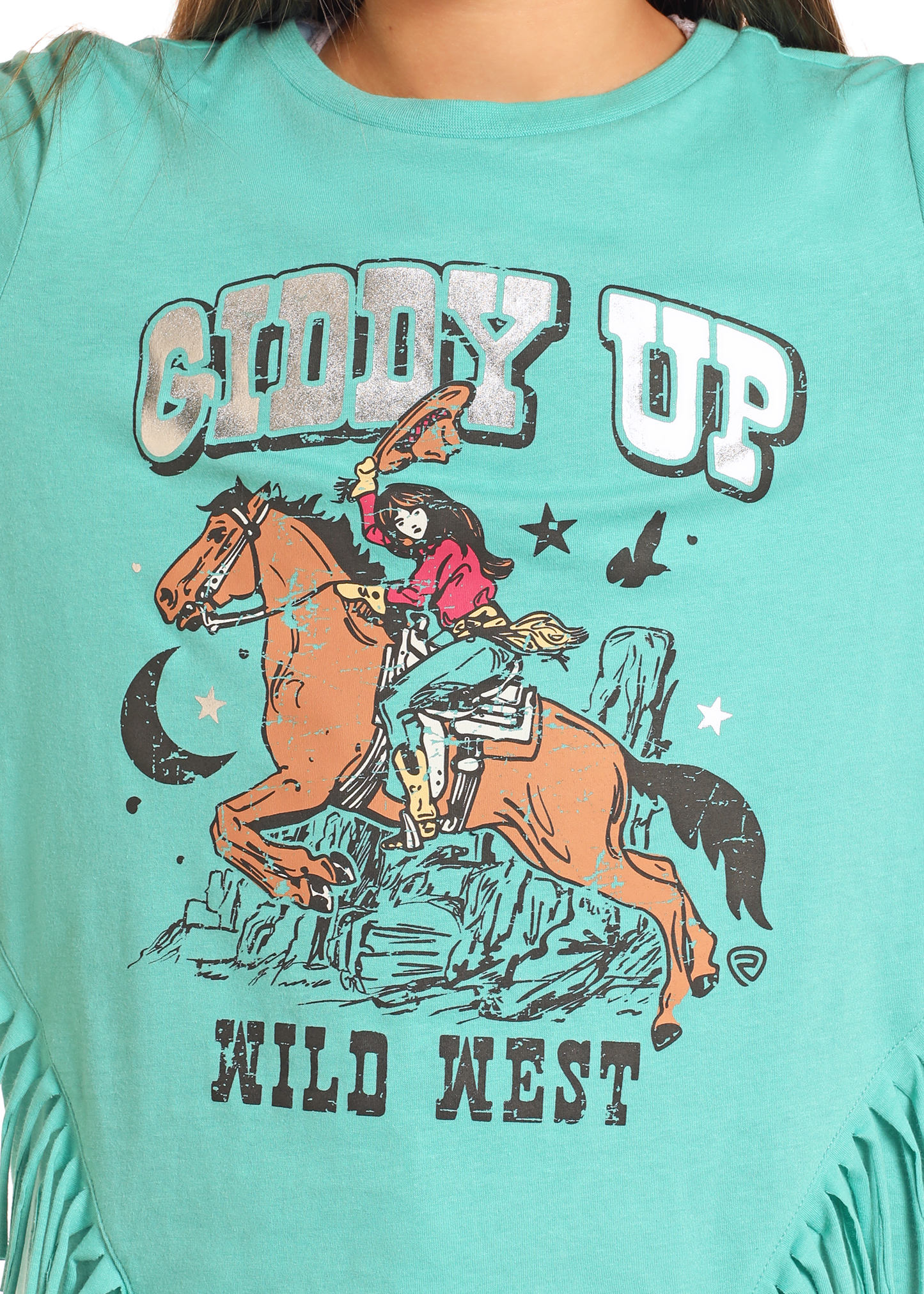 The Girls' Giddy Up Fringe Long Sleeve Tee by Rock & Roll Denim features a graphic of a cowgirl on horseback with cliffs, stars, and a moon. "Giddy Up" is printed above and "Wild West" below the image.