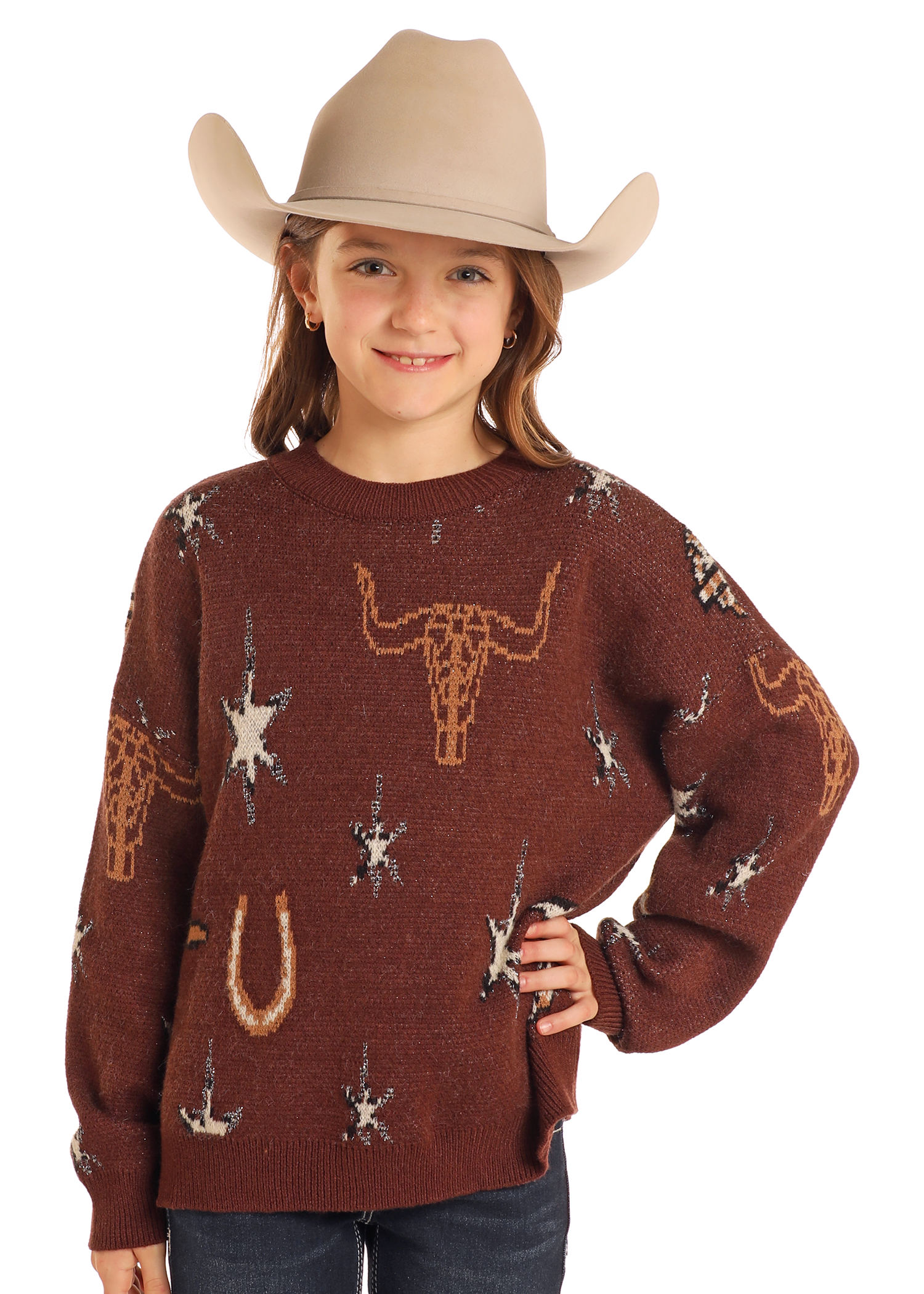 A young girl smiles with one hand on her hip, wearing the Rock & Roll Denim Girls' Western Print Sweater and a beige cowboy hat.