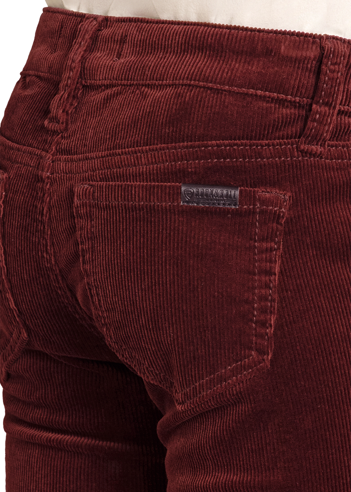 Close-up of maroon corduroy pants with a brand label.