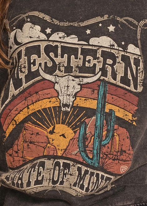 Young girl wearing a cowboy hat and graphic sweatshirt on a white background