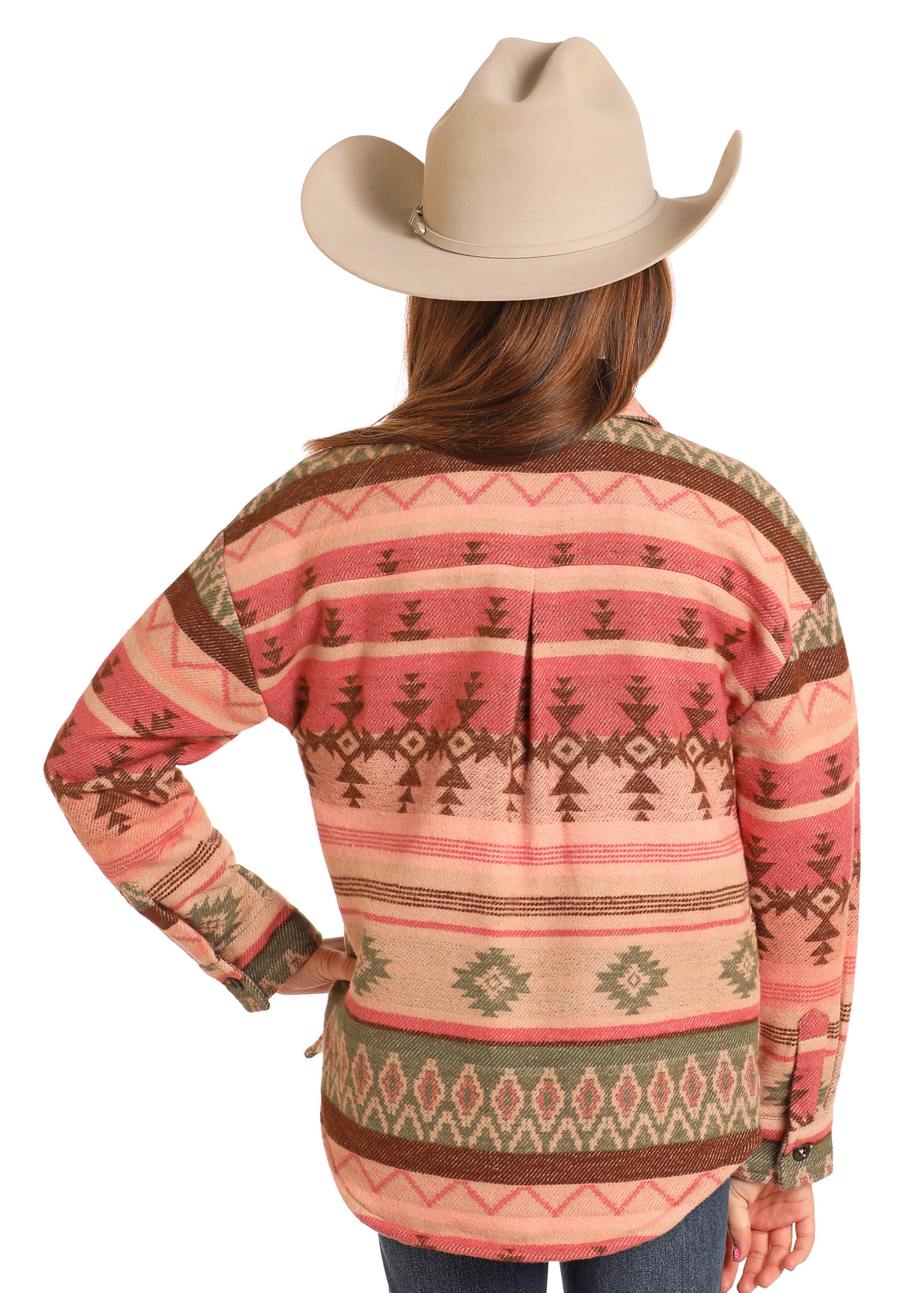 A person is shown from the back, wearing a wide-brimmed beige cowboy hat and the Rock & Roll Denim Girls' Pink Aztec Shirt Jacket, with one hand on their hip.