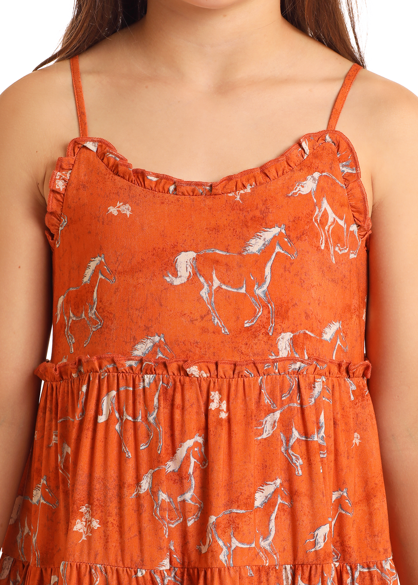 A close-up of the Rock & Roll Denim Girls' Horse Print Dress shows its orange sleeveless design with thin straps, ruffle trim, and playful white horse print. Only the upper body is visible.