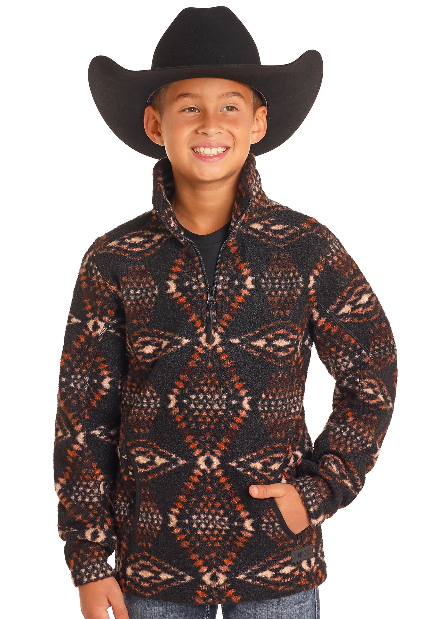 A smiling child in a black cowboy hat and Rock & Roll Denim Kids' Aztec Print Quarter Zip Pullover stands with hands in pockets against a plain white background.