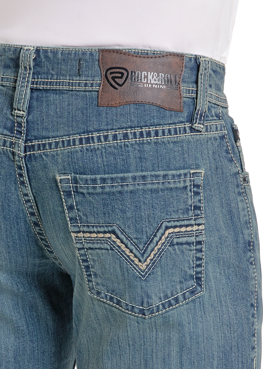 A close-up of the Relaxed Fit Two Tone Bootcut Jeans shows detailed pocket stitching and a brown leather patch with the Rock & Roll Denim logo on the waistband.