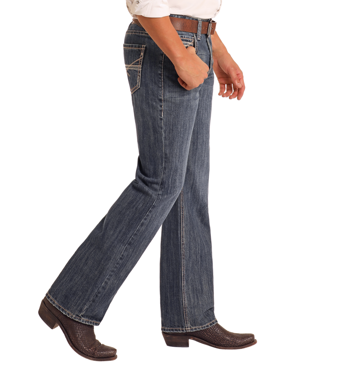 A person wears Rock & Roll Denim Relaxed Fit Criss-Cross Stitch Straight Leg Jeans, a white shirt, brown belt, and cowboy boots on a white background. Only the lower half of their body is visible.