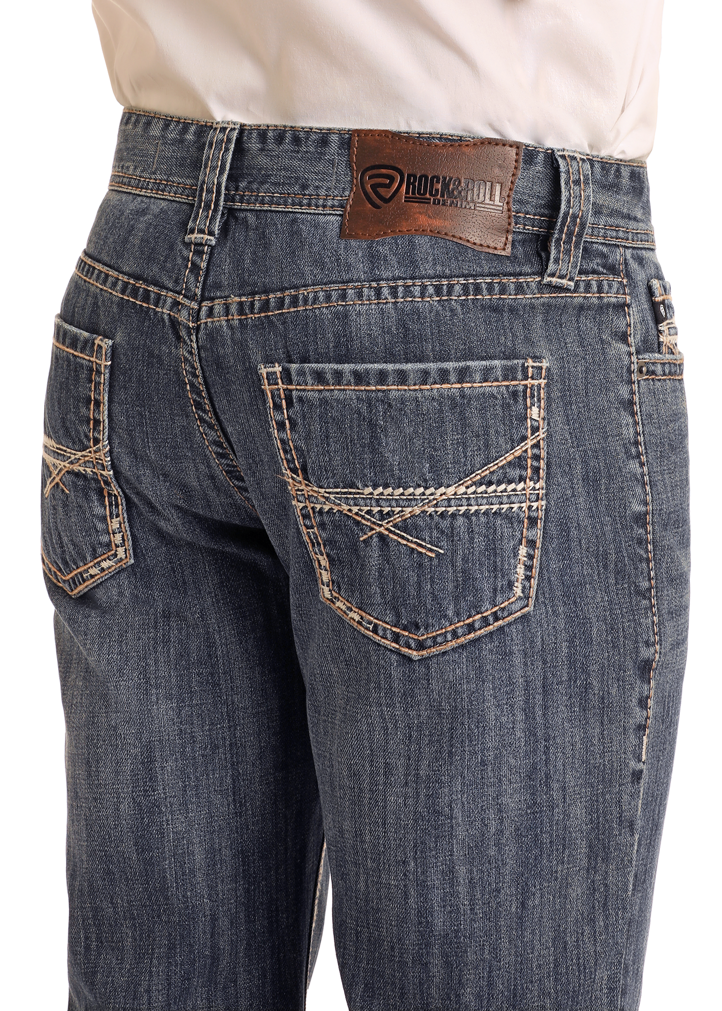 A person wearing Rock & Roll Denim Relaxed Fit Criss-Cross Stitch Straight Leg Jeans; medium wash, tan stitching, brown leather brand patch on the waistband; visible from waist to mid-thigh, hands out of frame.