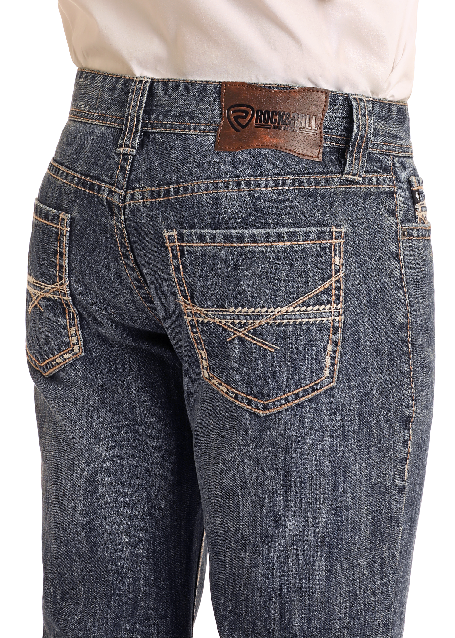 A person wearing Rock & Roll Denim Relaxed Fit Criss-Cross Stitch Straight Leg Jeans; medium wash, tan stitching, brown leather brand patch on the waistband; visible from waist to mid-thigh, hands out of frame.
