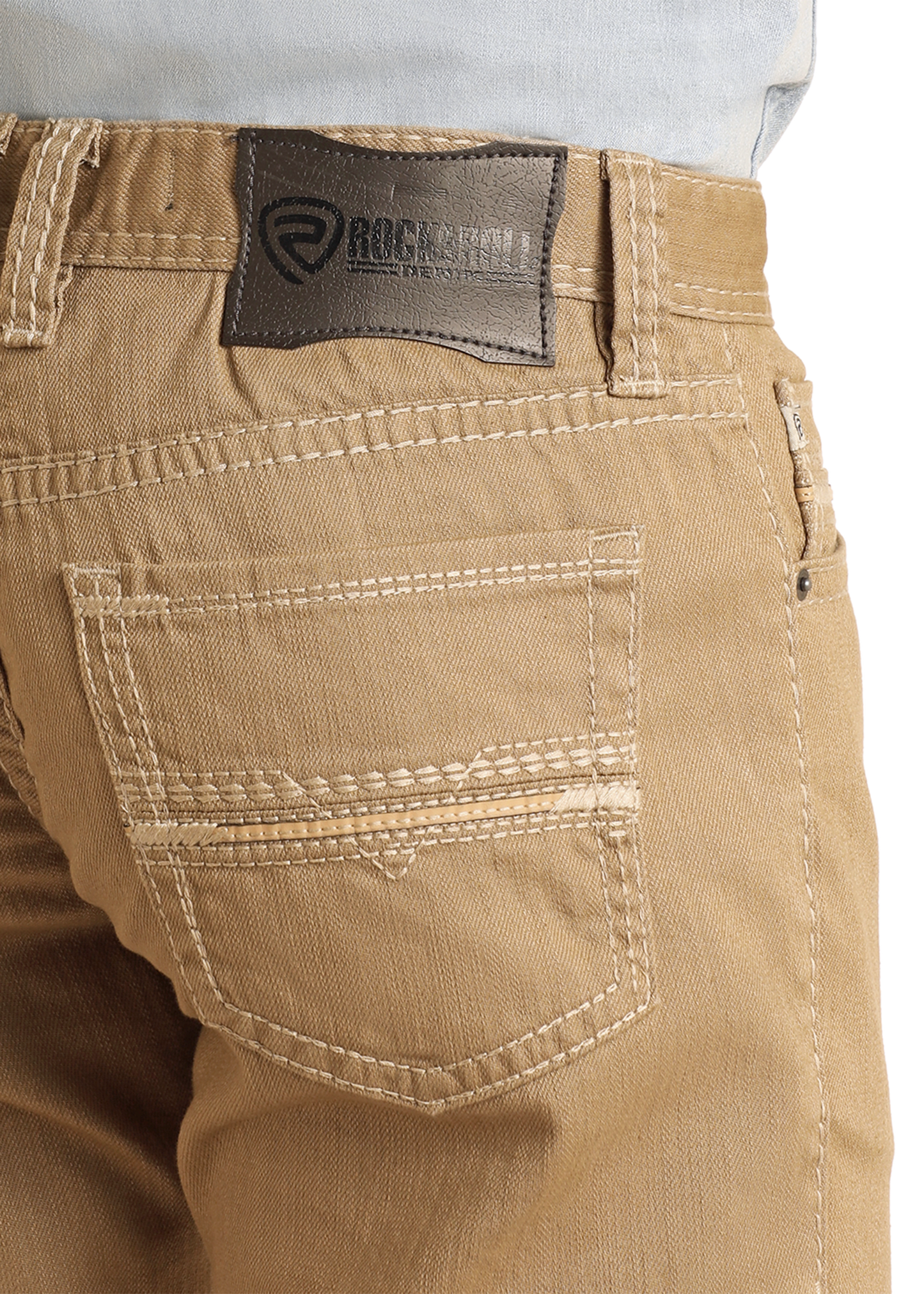 Close-up of beige pants with a brand label on a white background