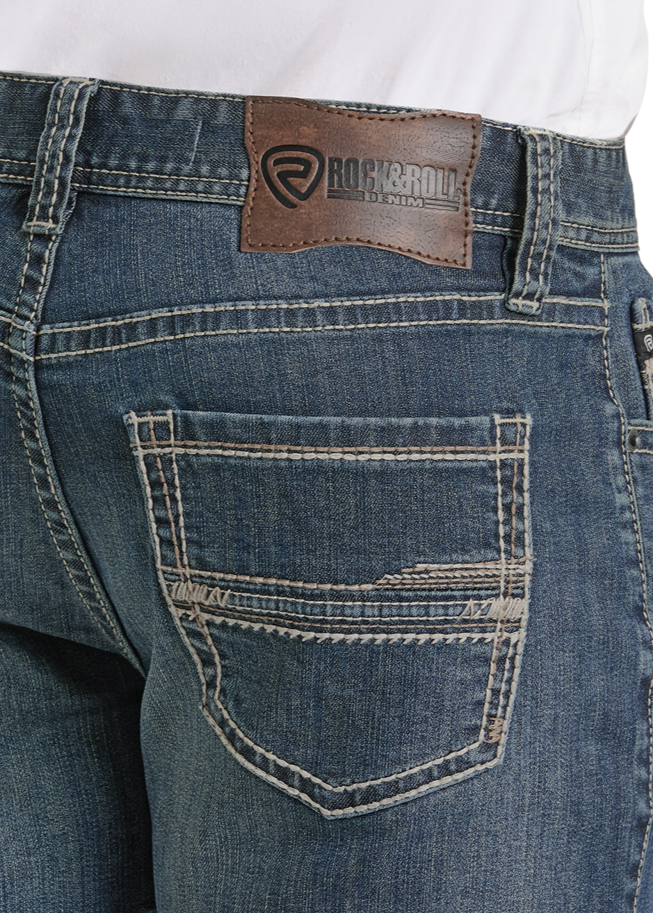 Blue jeans with a brand patch on a white background