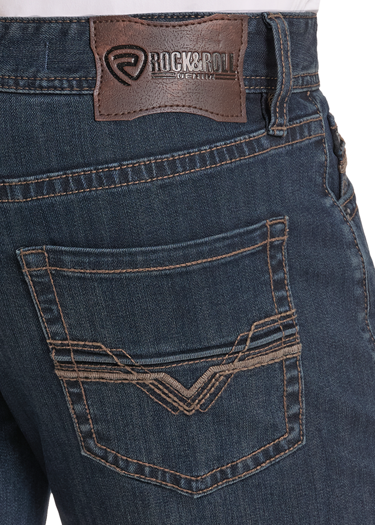 Close-up of the back waistband and back pocket of dark blue denim jeans, showing a brown leather Rock & Roll brand patch and contrast stitching.