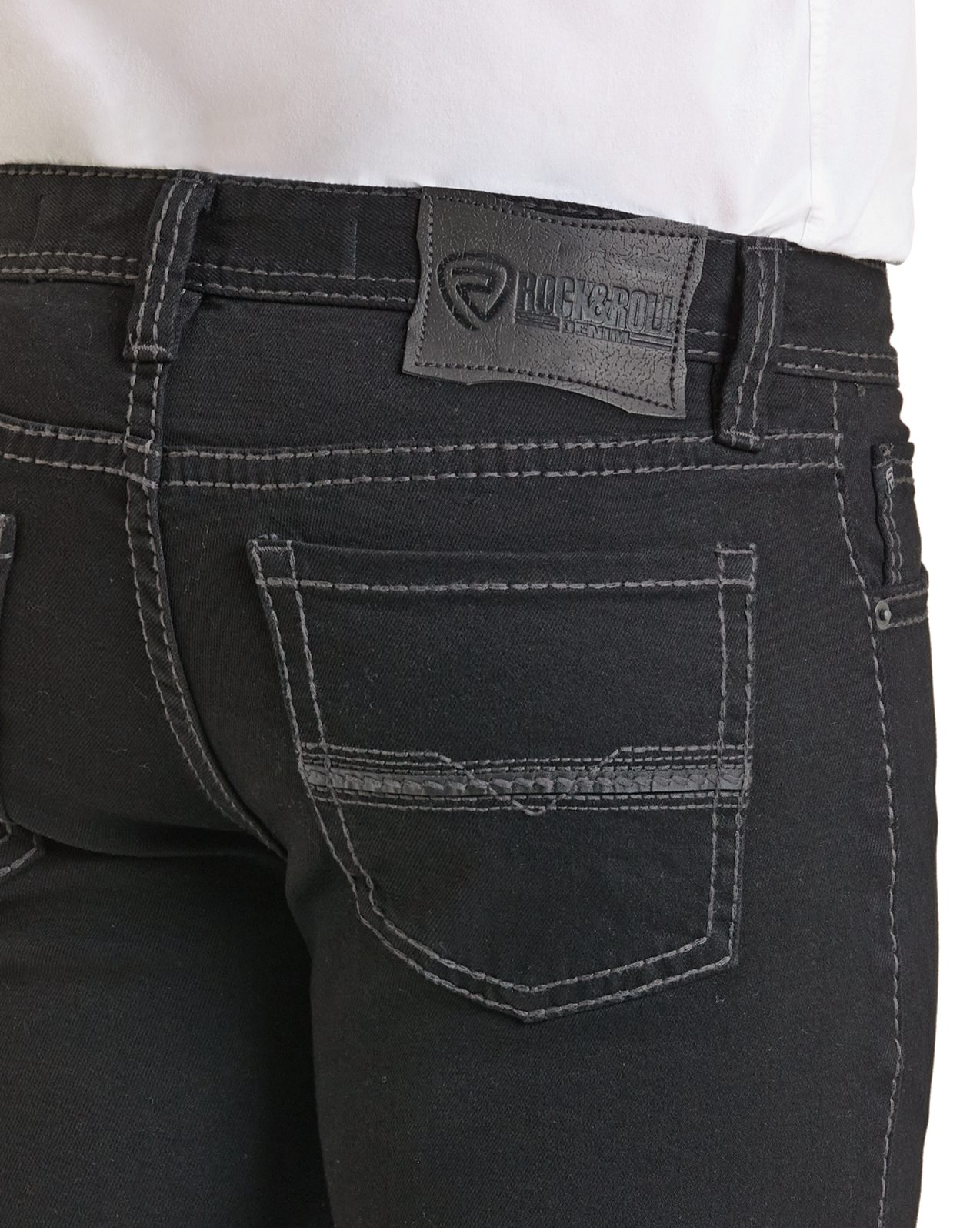 Close-up of the back pocket area of Rock & Roll Denim Regular Fit Black Straight Leg Jeans, featuring white stitching, a leather brand patch on the waistband, and part of a tucked-in white shirt.