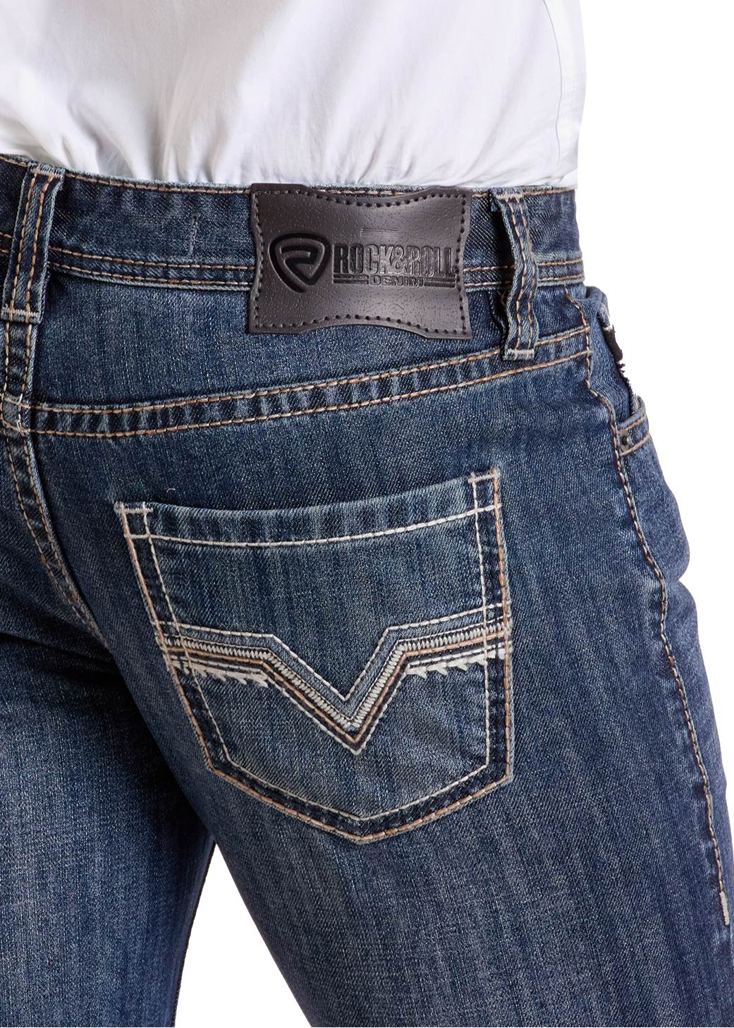 A person wears Rock & Roll Denim Regular Fit V Stitch Straight Leg Jeans in dark blue with white stitching, decorative back pockets, and a black leather logo patch, paired with a tucked-in white shirt.
