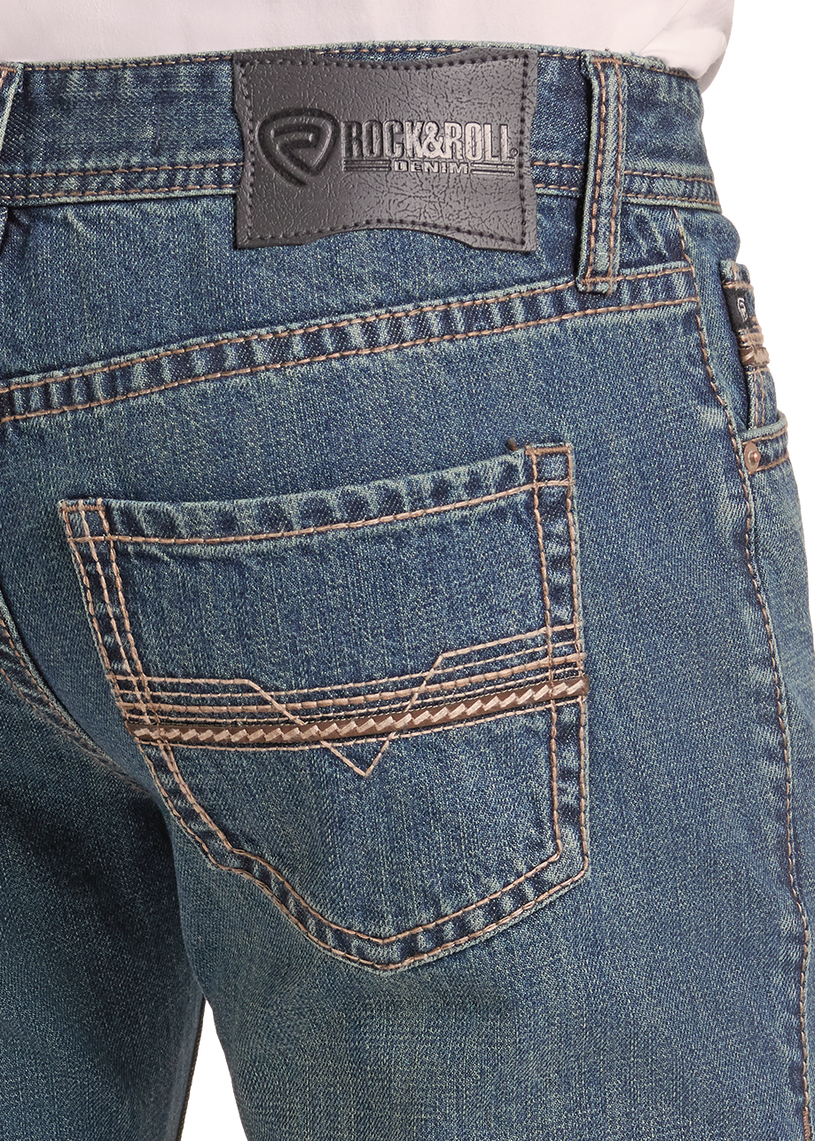 Close-up of the back waistband and pocket area of blue denim jeans, showing a dark gray Rock & Roll brand patch and contrast tan stitching.