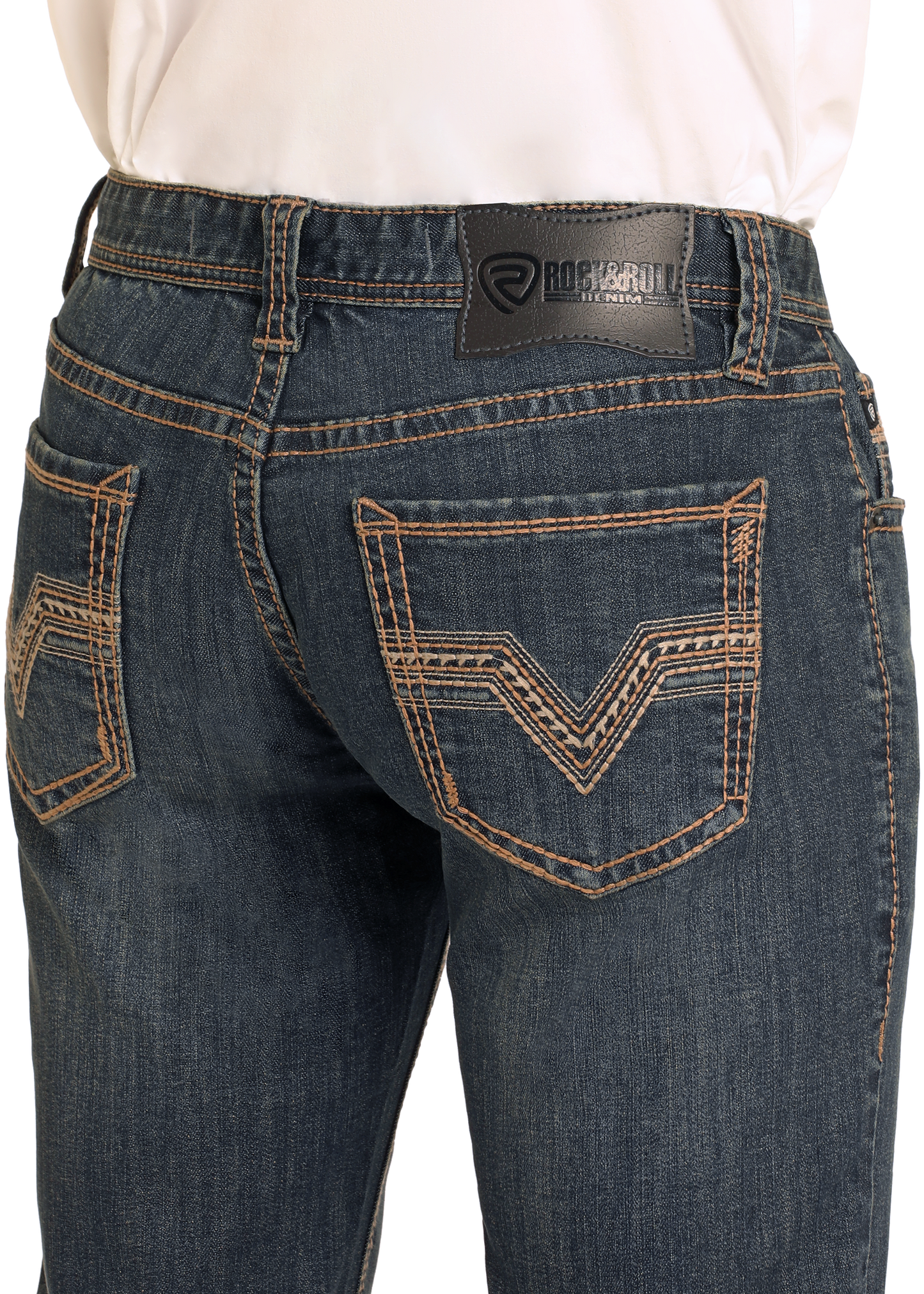 Close-up of the back of a person wearing dark wash Rock & Roll Denim Slim Fit Thick Stitch Straight Leg Jeans with tan stitching, patterned back pockets, and a visible black leather Rock & Roll Denim patch on the waistband.