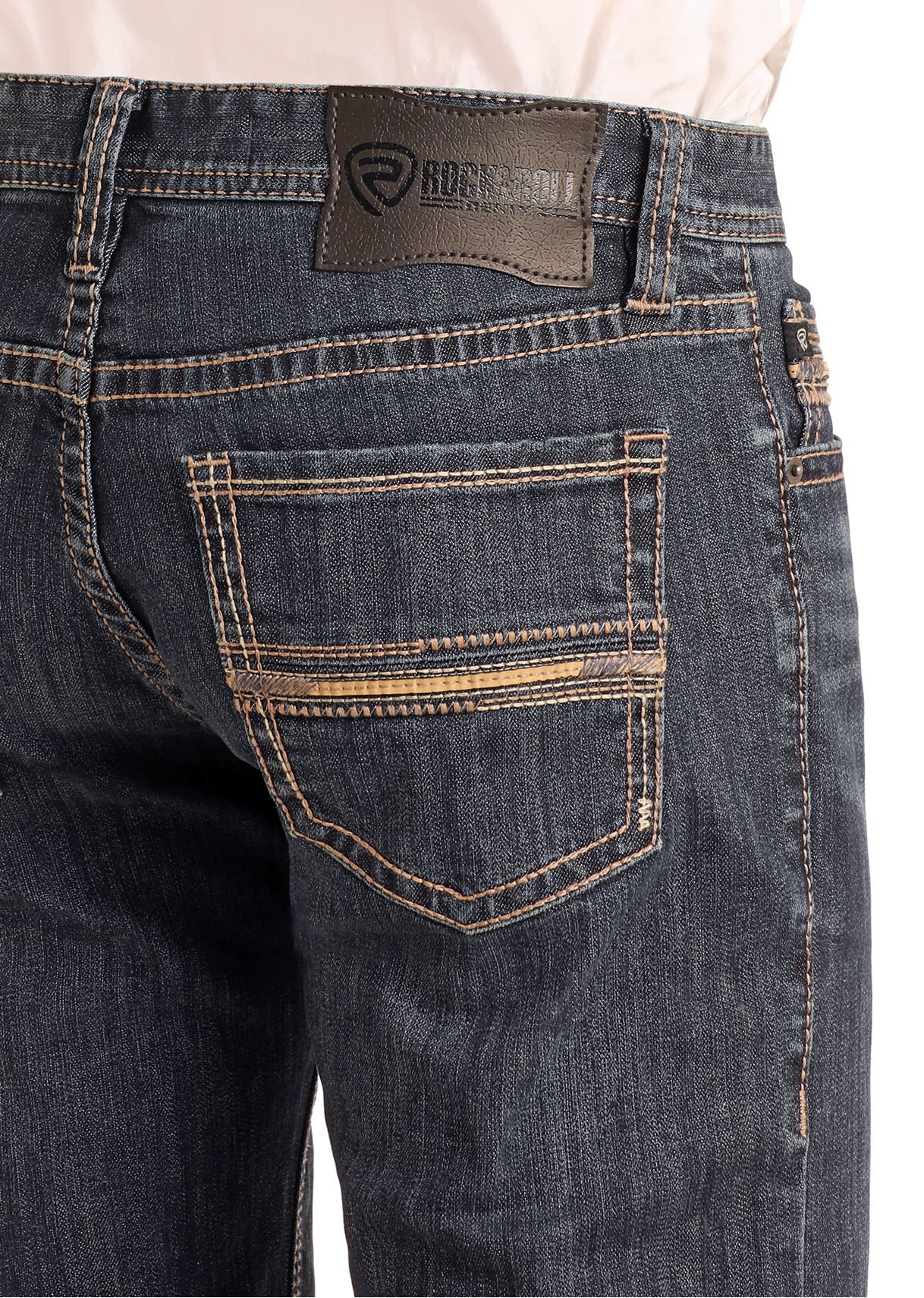 Close-up of the back of a person wearing Slim Fit Ladder Pocket Stitch Straight Leg Jeans by Rock & Roll Denim in dark blue, featuring contrast stitching, multiple pockets, and a black leather patch with the brand logo on the waistband.