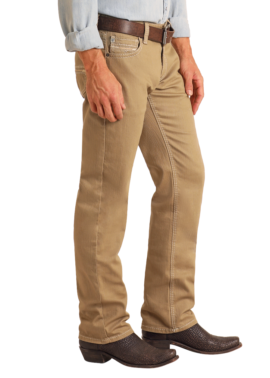 A person wears Rock & Roll Denim Khaki Slim Straight Jeans, a brown belt, light blue shirt, and dark brown cowboy boots, shown from mid-chest down against a white background.