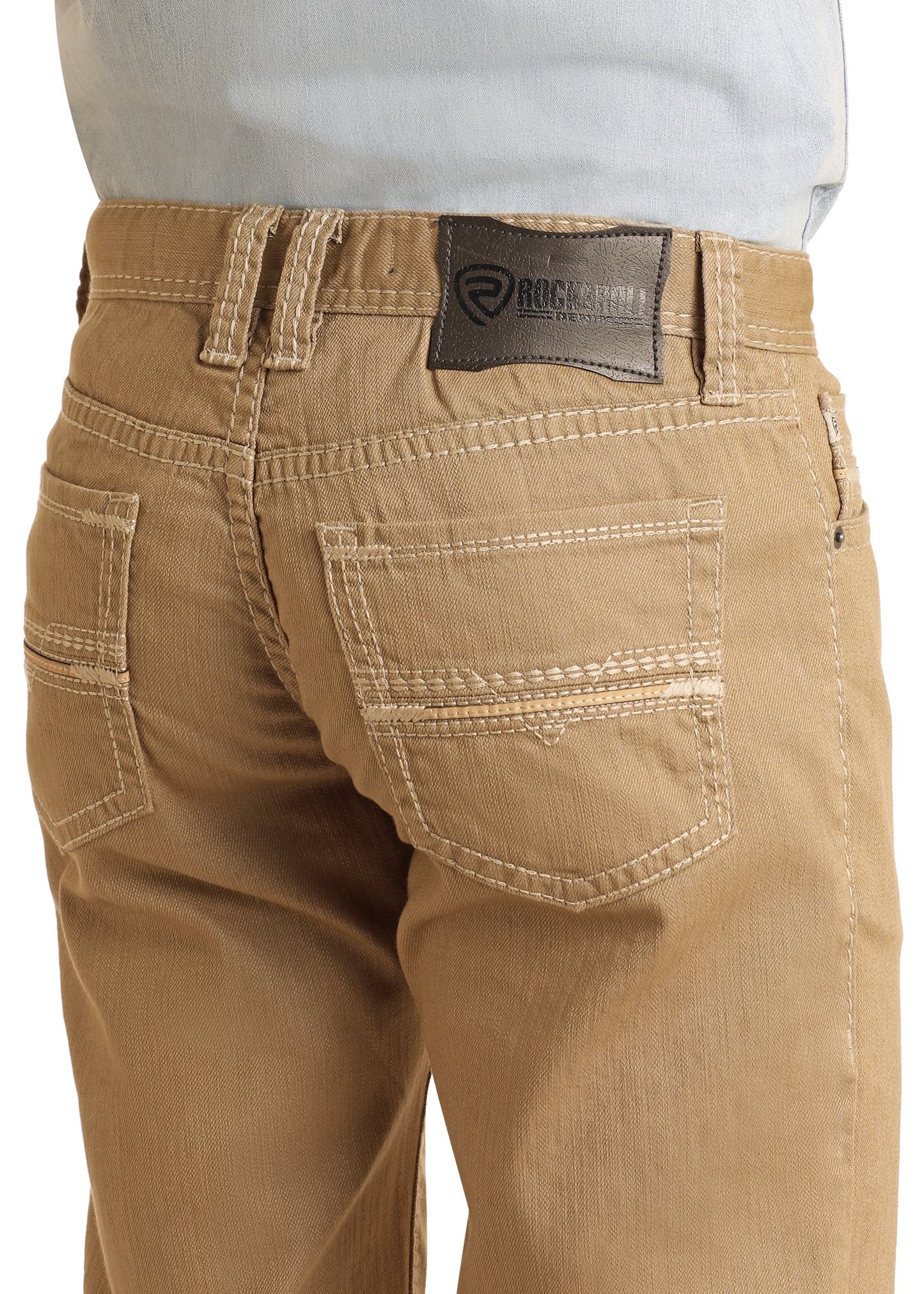 Close-up of the back of a person wearing Rock & Roll Denim Khaki Slim Straight Jeans with white stitching and a dark leather brand patch, styled with a light blue shirt tucked in for a classic slim fit look.