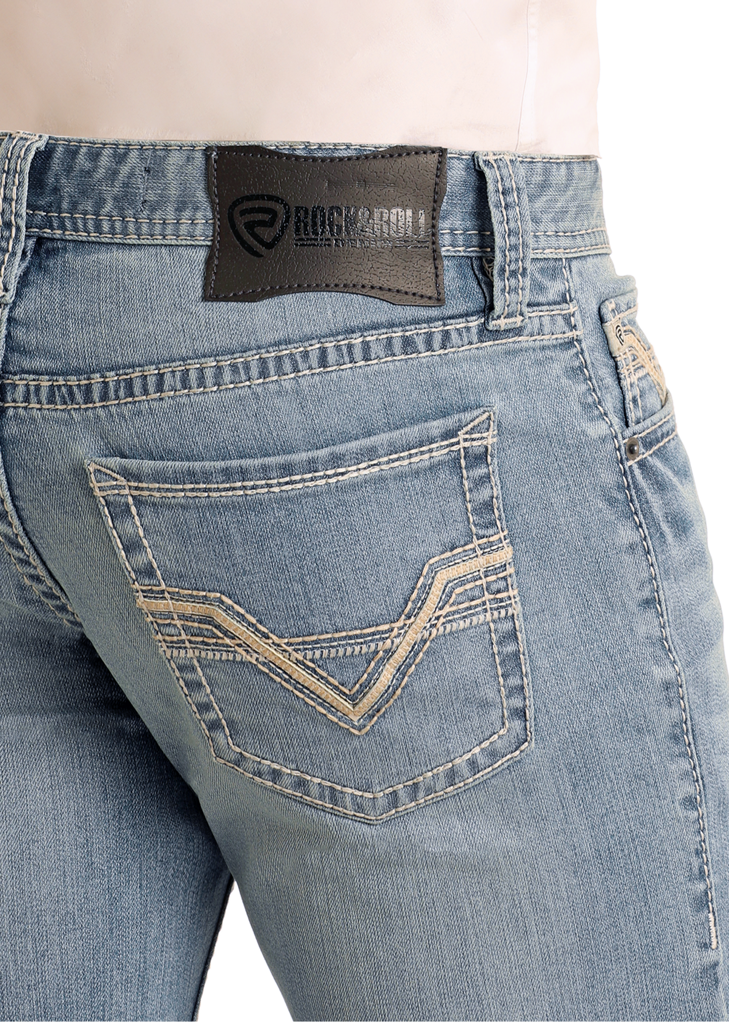 Close-up of a person wearing Rock & Roll Denim Slim Fit Ladder Pocket Straight Leg Jeans in light wash, featuring white stitching and a black leather brand patch on the back waistband.