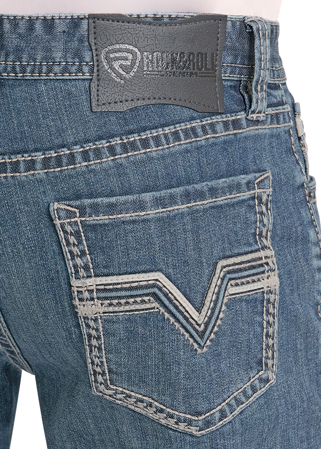 Close-up of blue jeans with a brand logo on the pocket and waistband.