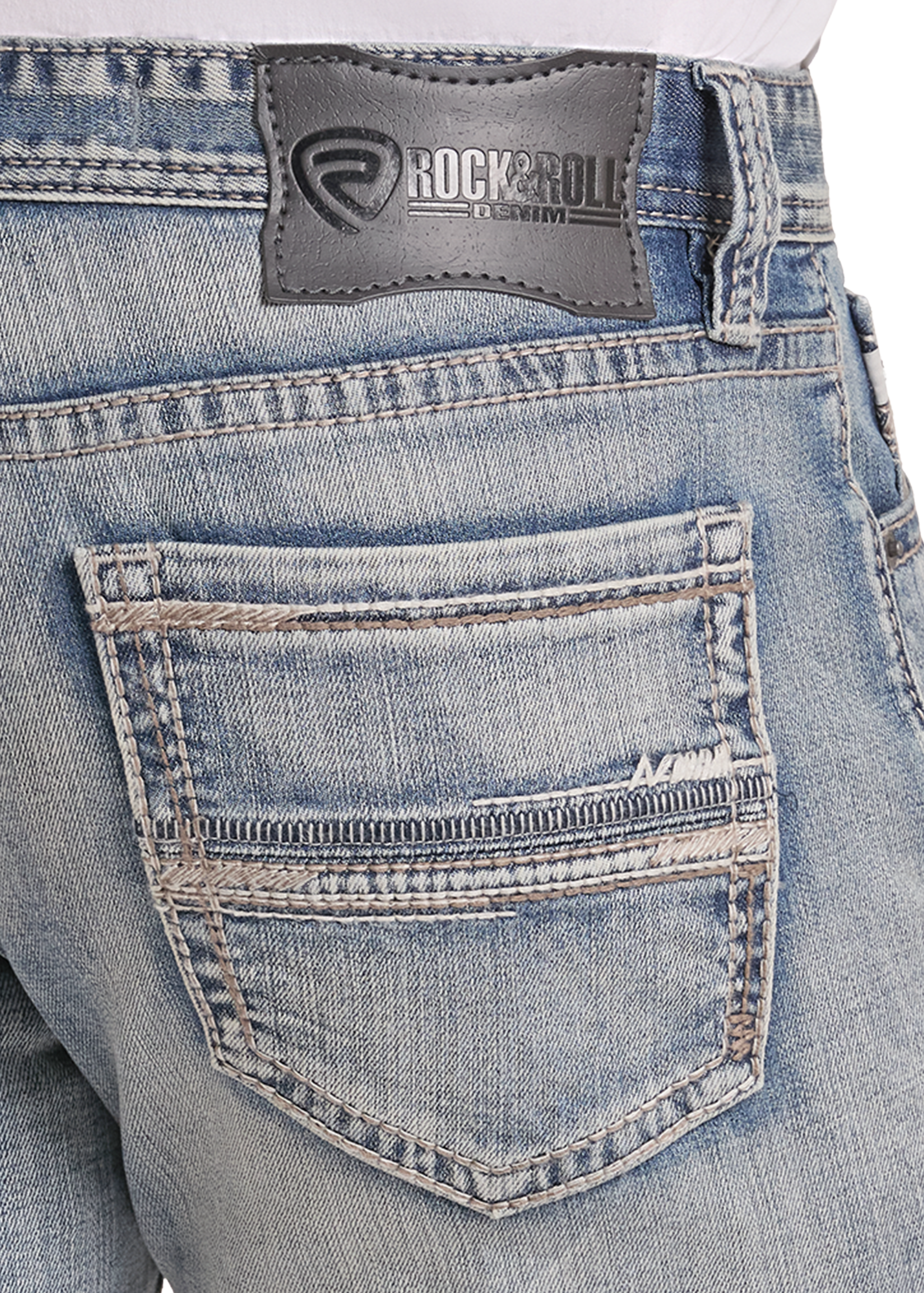 Close-up of the back waistband and pocket of light-wash blue denim jeans, showing a Rockroll brand patch on the waistband.