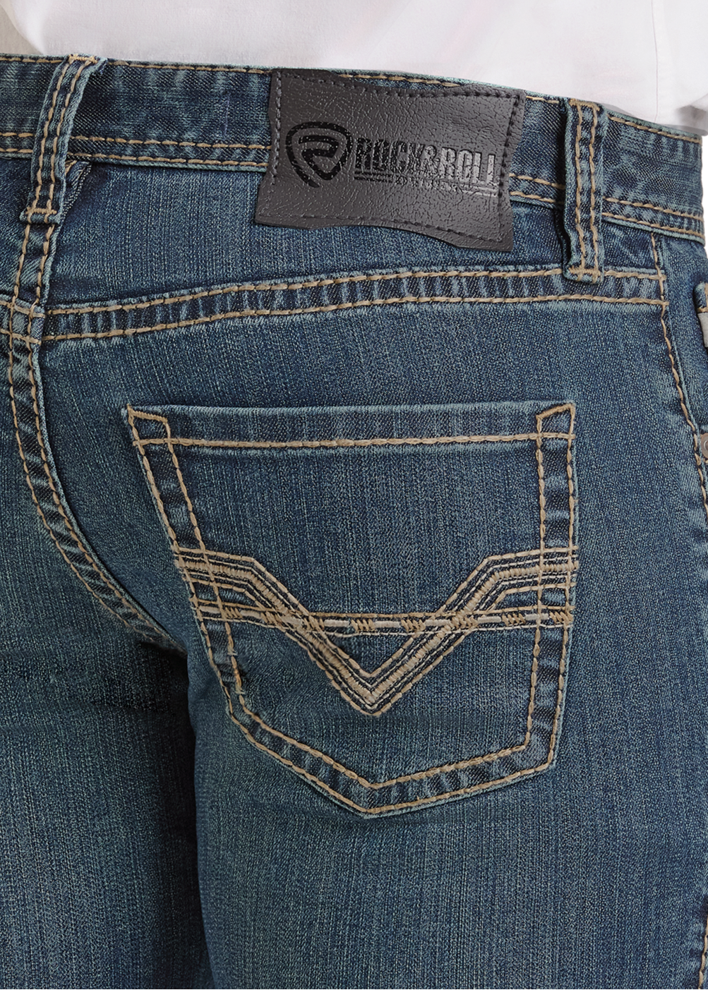 Close-up of the back of Skinny Fit Wire Embroidered Straight Leg Jeans by Rock & Roll Denim, showing the stitched pocket detail and black leather brand patch near the waistband. A white shirt is partly visible at the top.