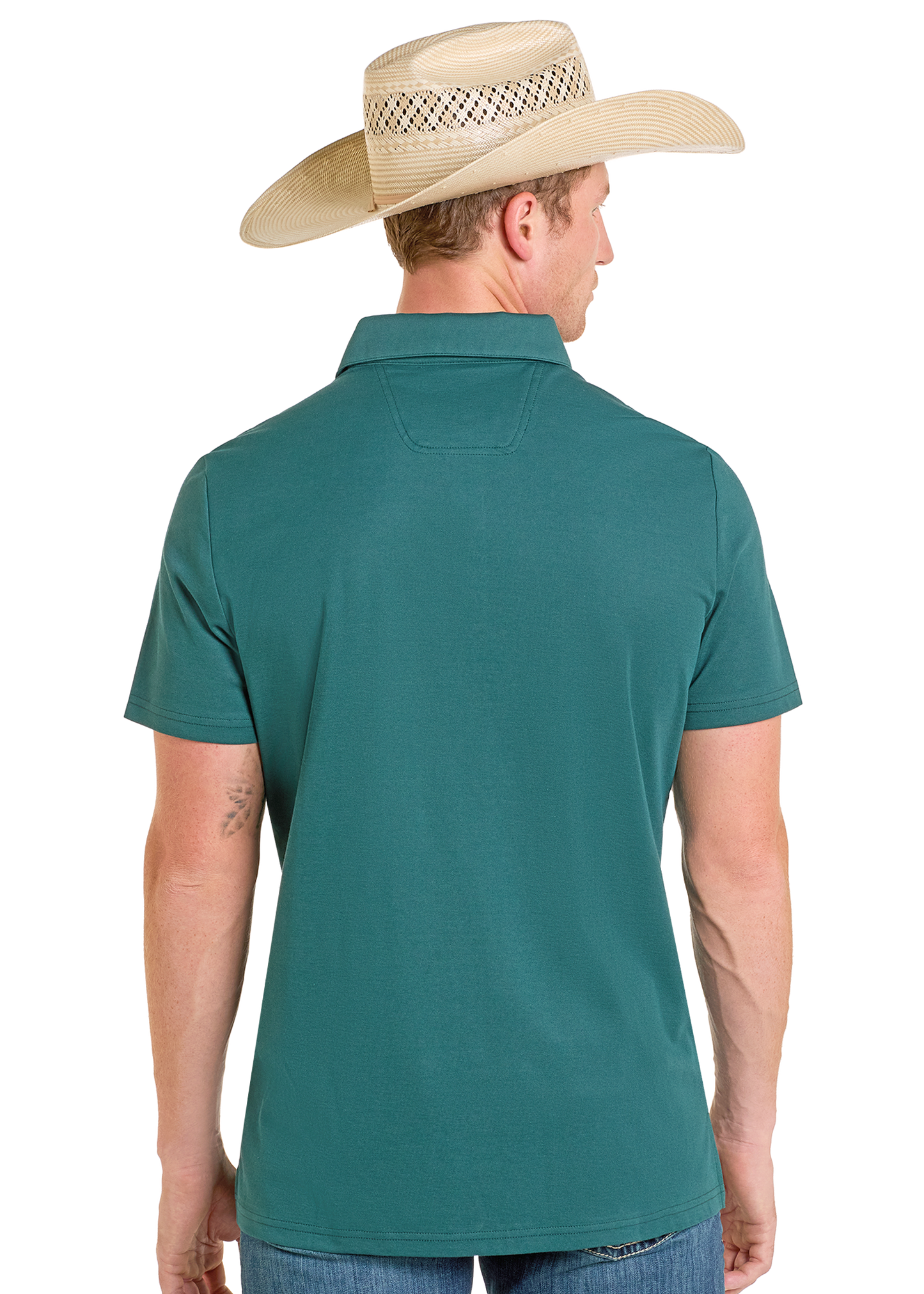 A man in a Rock & Roll Denim Border Print Polo and blue jeans, wearing a straw cowboy hat, stands with his back to the camera against a plain white background.