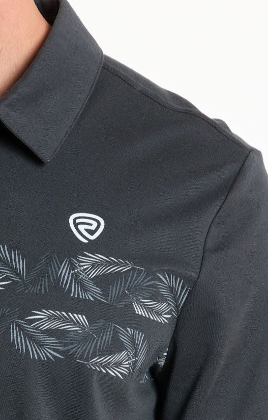 A close-up of the Rock & Roll Denim Charcoal Palm Border Polo - M shows a regular fit in dark grey, featuring a white abstract logo and light grey palm leaves across the chest with only the shoulder, chest, and collar area visible.