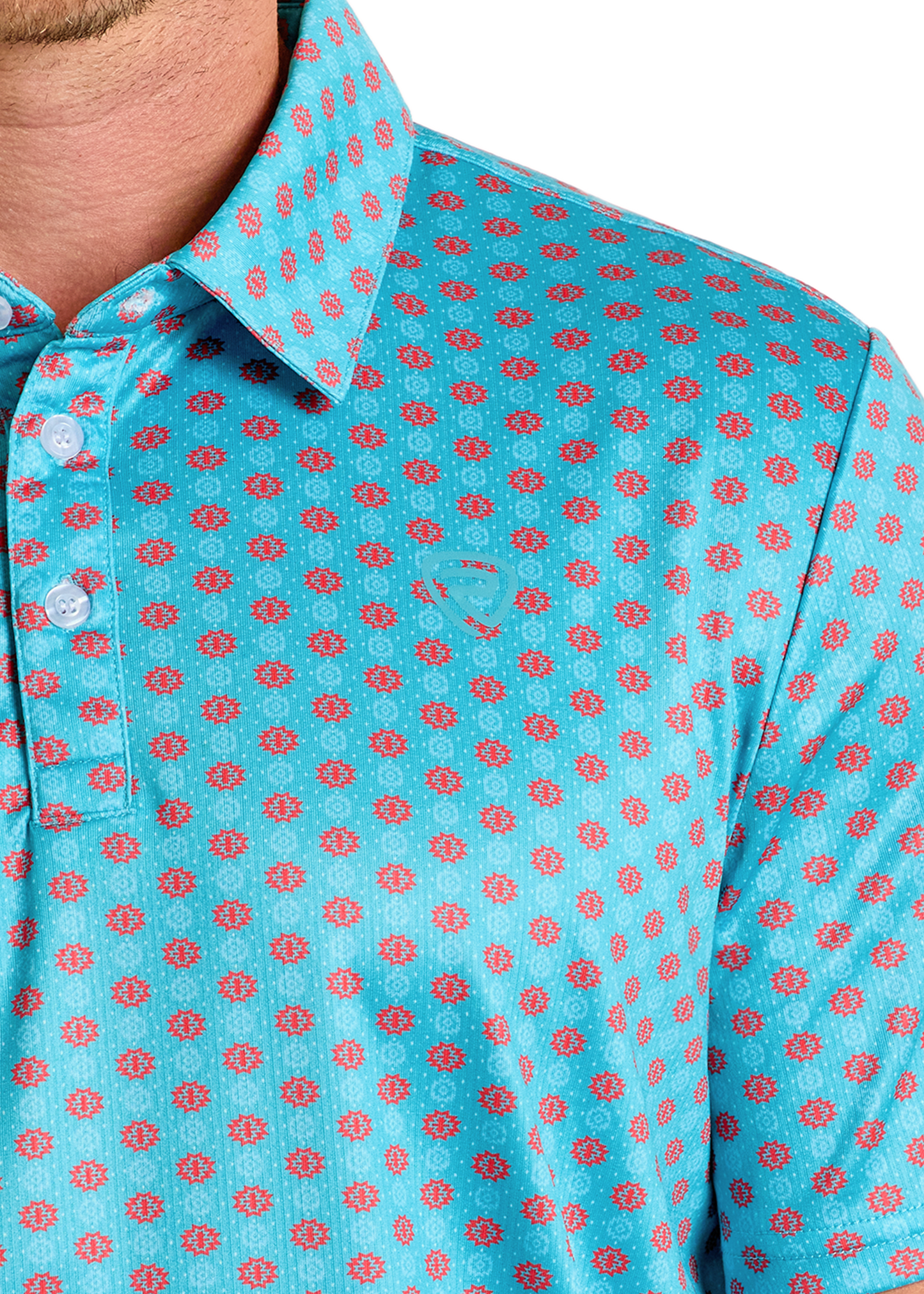 A close-up shows the lower face, neck, and shoulder of a person wearing the Rock & Roll Denim Turquoise Geo Print Polo, featuring white buttons, a stylish regular fit, and an eye-catching geometric pattern.