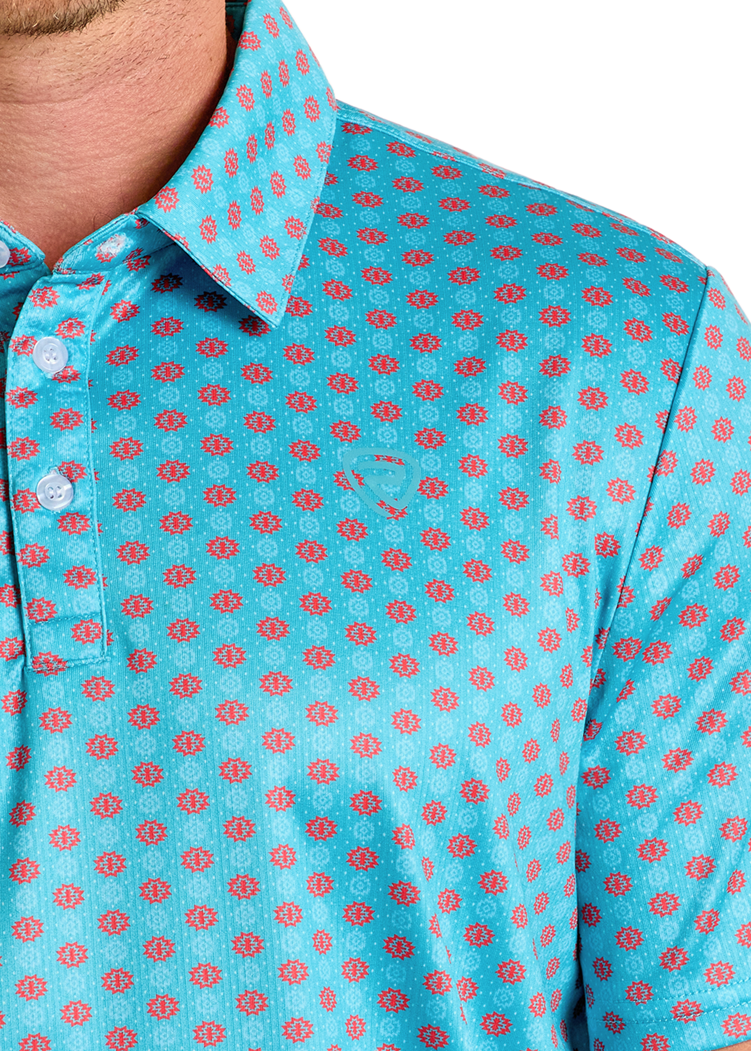 A close-up shows the lower face, neck, and shoulder of a person wearing the Rock & Roll Denim Turquoise Geo Print Polo, featuring white buttons, a stylish regular fit, and an eye-catching geometric pattern.