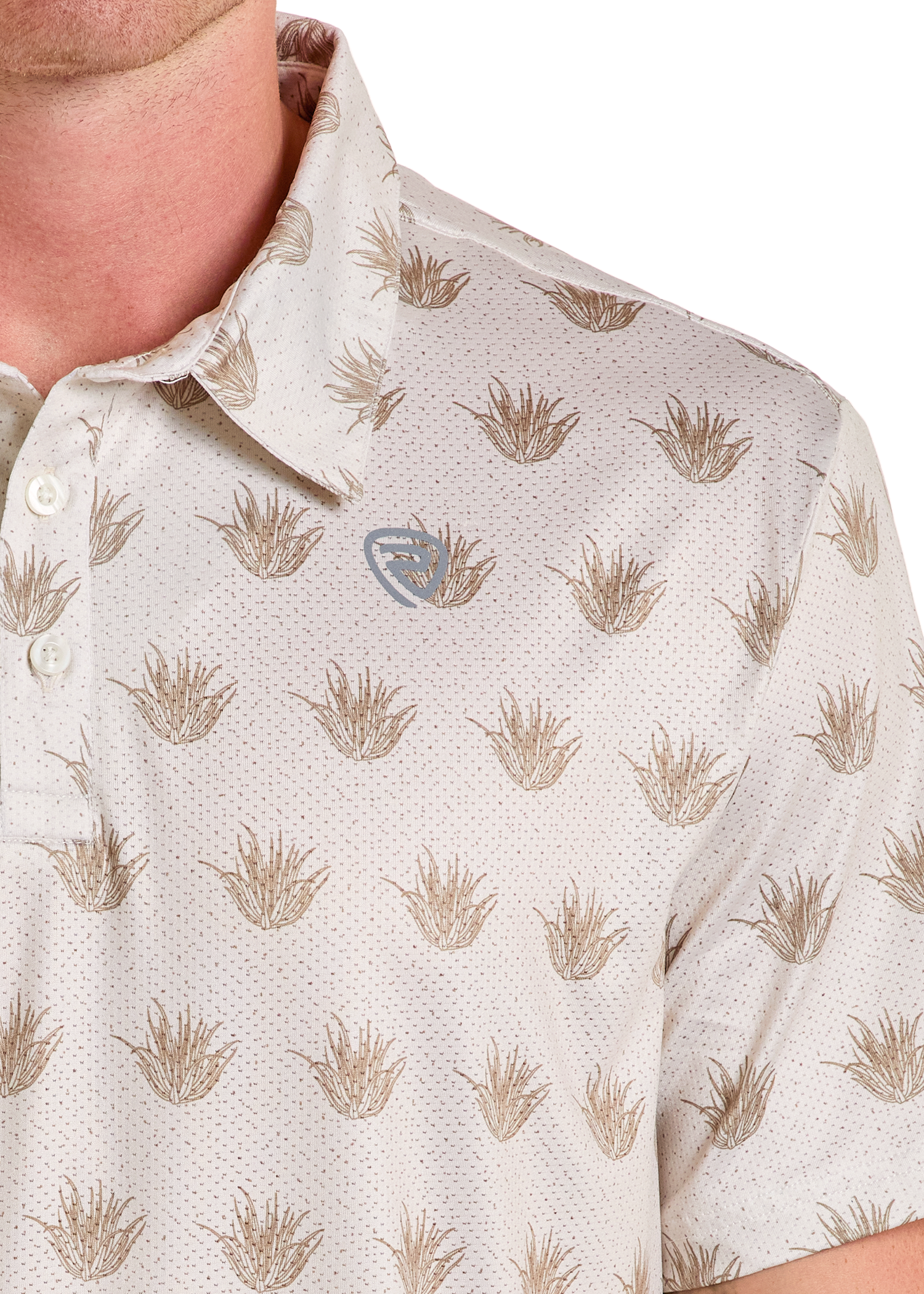 A close-up shows a person in a light-colored Rock & Roll Denim Cactus Print Polo, featuring a brown plant-like pattern and a small chest logo. Only the lower face, neck, and upper torso are visible in this casual style.