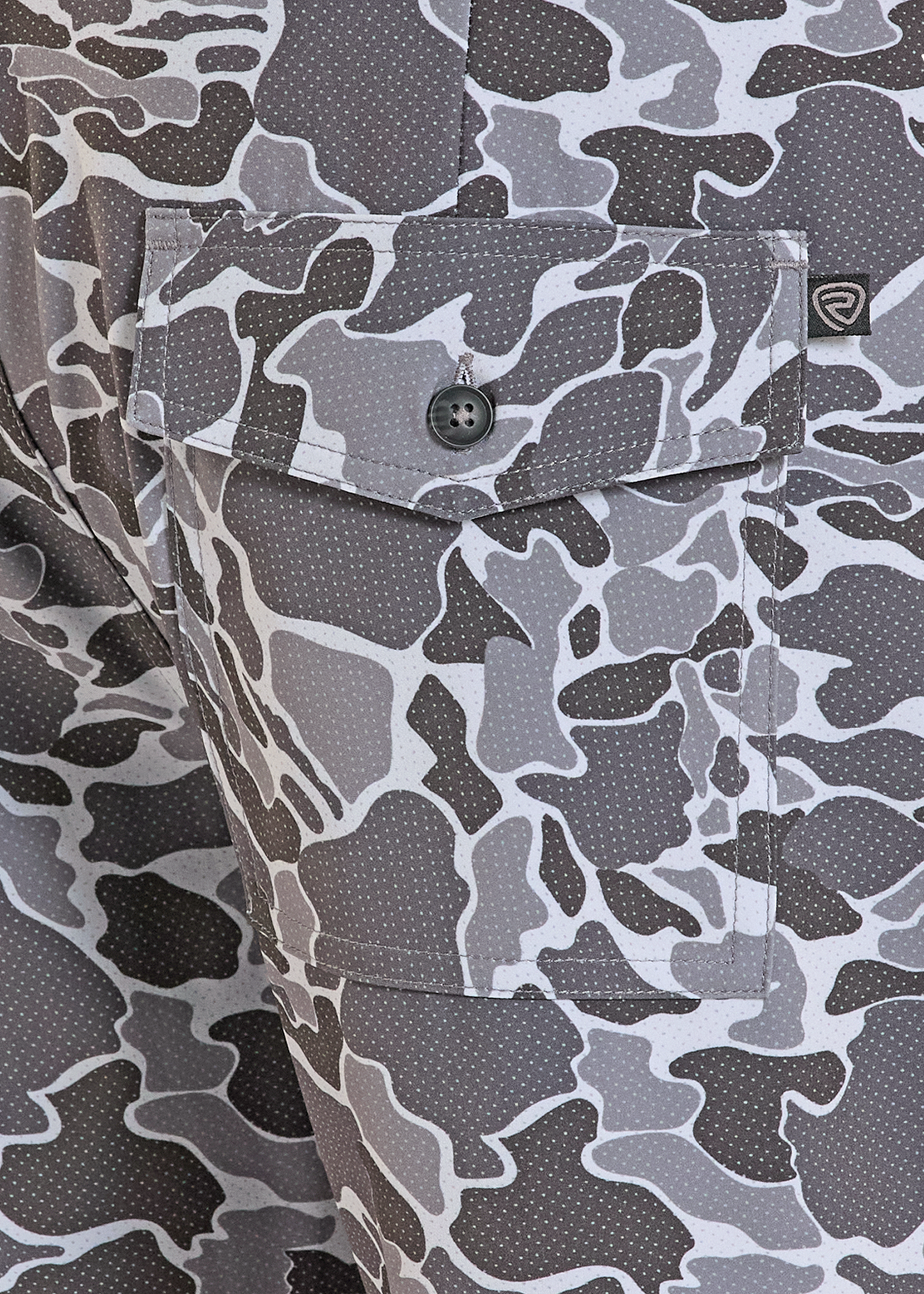 Close-up of a camouflage-patterned shirt with a button and brand logo.
