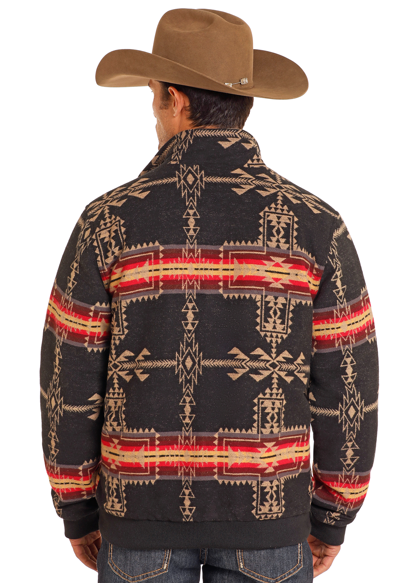 A man seen from behind wears a brown cowboy hat, blue jeans, and a Rock & Roll Denim Large Aztec Jacquard Bomber Jacket with black, red, and tan geometric designs.