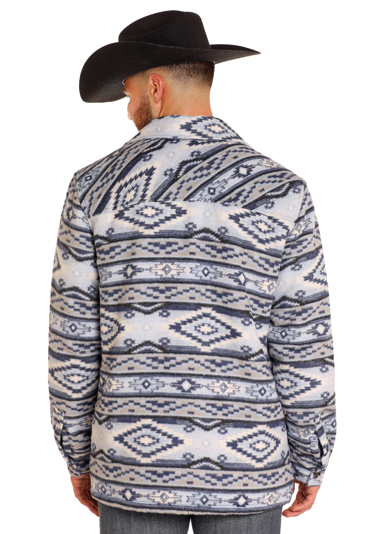 A man in a black cowboy hat stands facing away, wearing the Rock & Roll Denim Aztec Brushed Jacquard Shirt Jacket with geometric patterns and a sherpa lining.