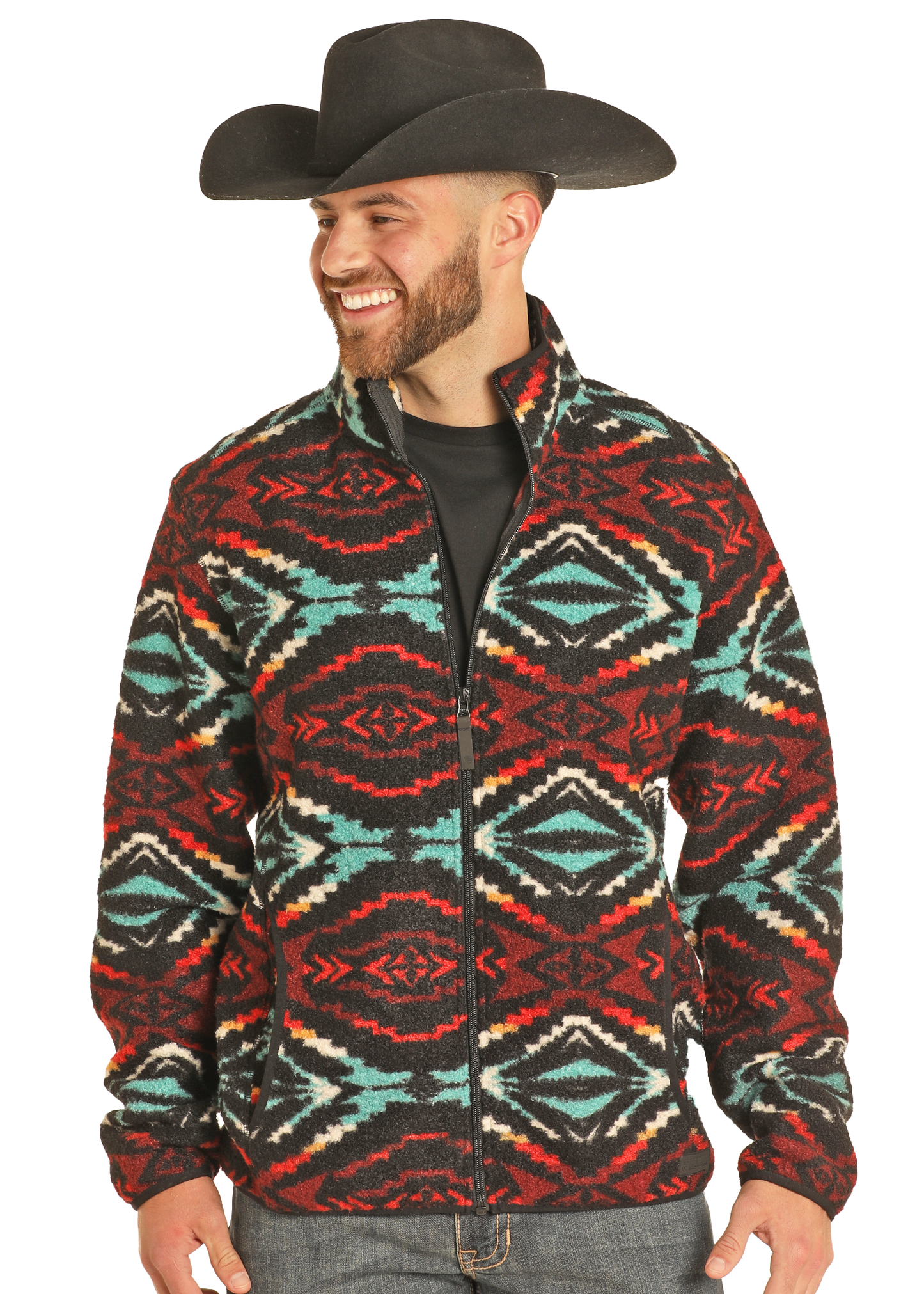 A smiling man in a black cowboy hat, black shirt, and the Rock & Roll Denim Aztec Print Berber Jacket with bold red, teal, white, and black geometric accents stands against a plain white background.