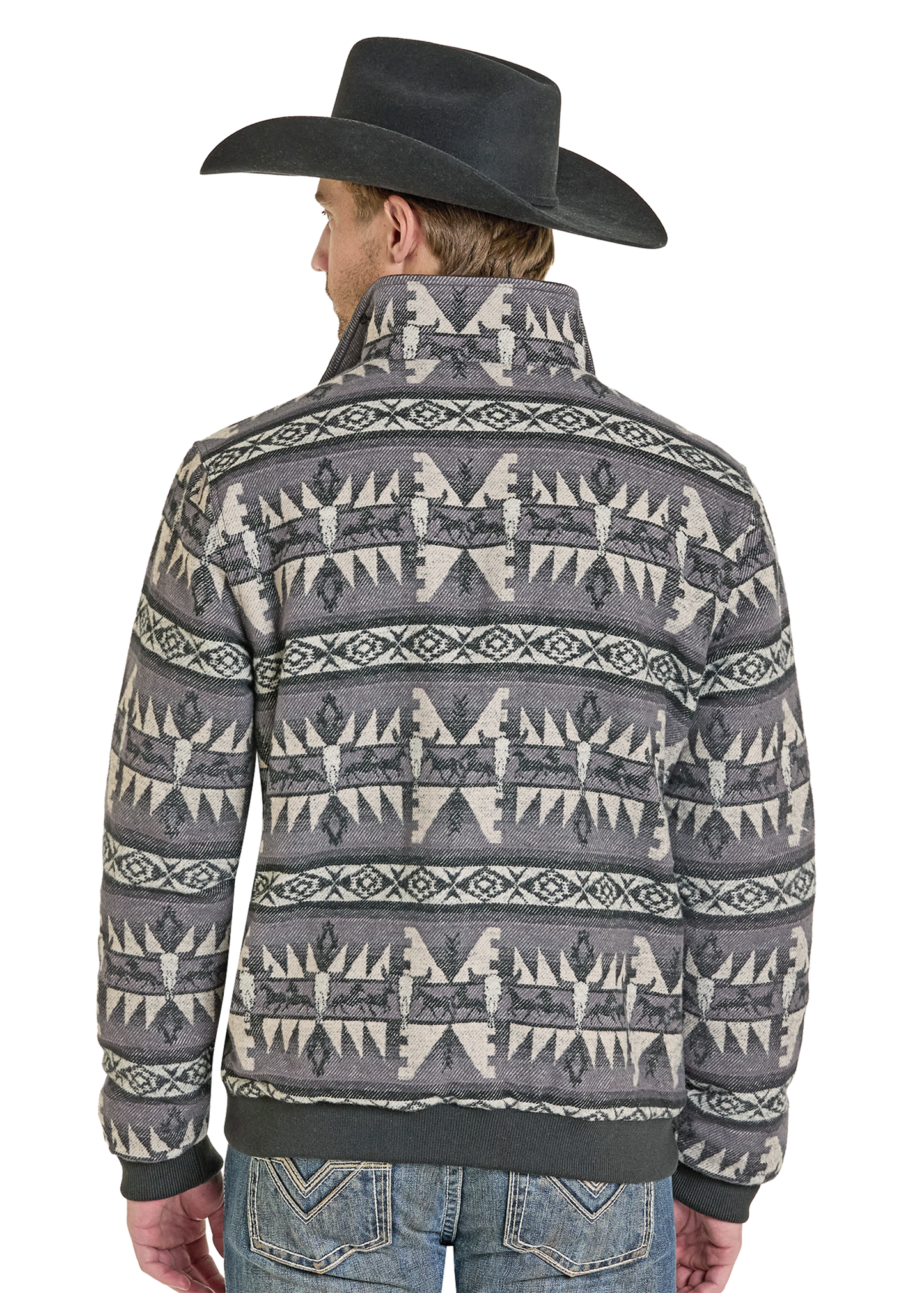 A man in a black cowboy hat and blue jeans is seen from behind, wearing the Rock & Roll Denim Jacquard Aztec Horse Bomber Jacket with gray and white geometric designs.