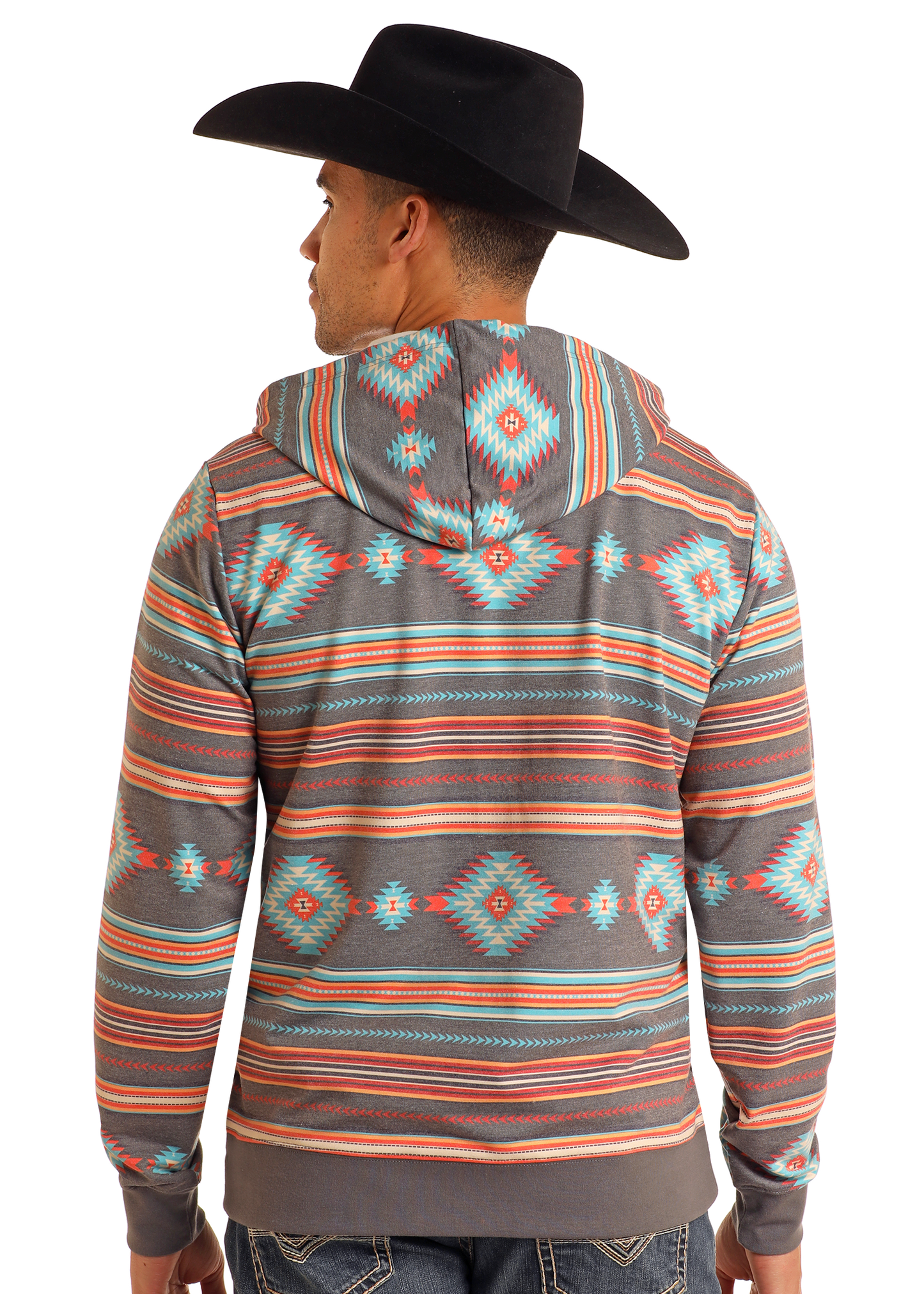 A man wearing a black cowboy hat and a Rock & Roll Denim Grey Aztec Print Hoodie with bold southwestern geometric designs stands facing away, highlighting the vibrant back of the hoodie.
