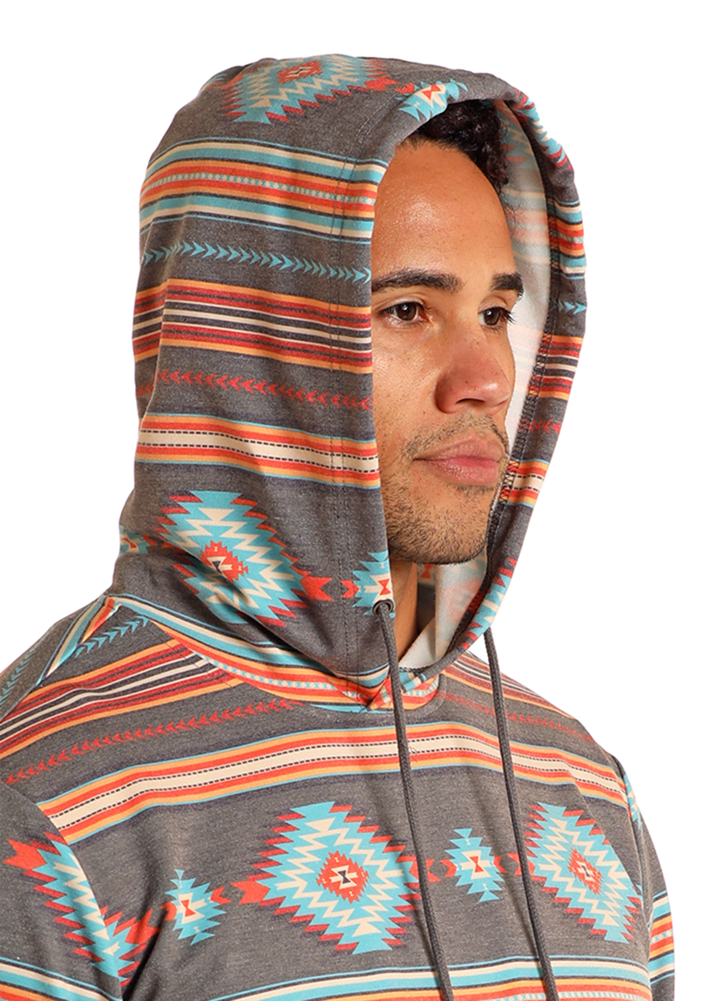 A person in a Rock & Roll Denim Grey Aztec Print Hoodie with turquoise, orange, and gray geometric patterns stands against a plain background, looking slightly to the side.